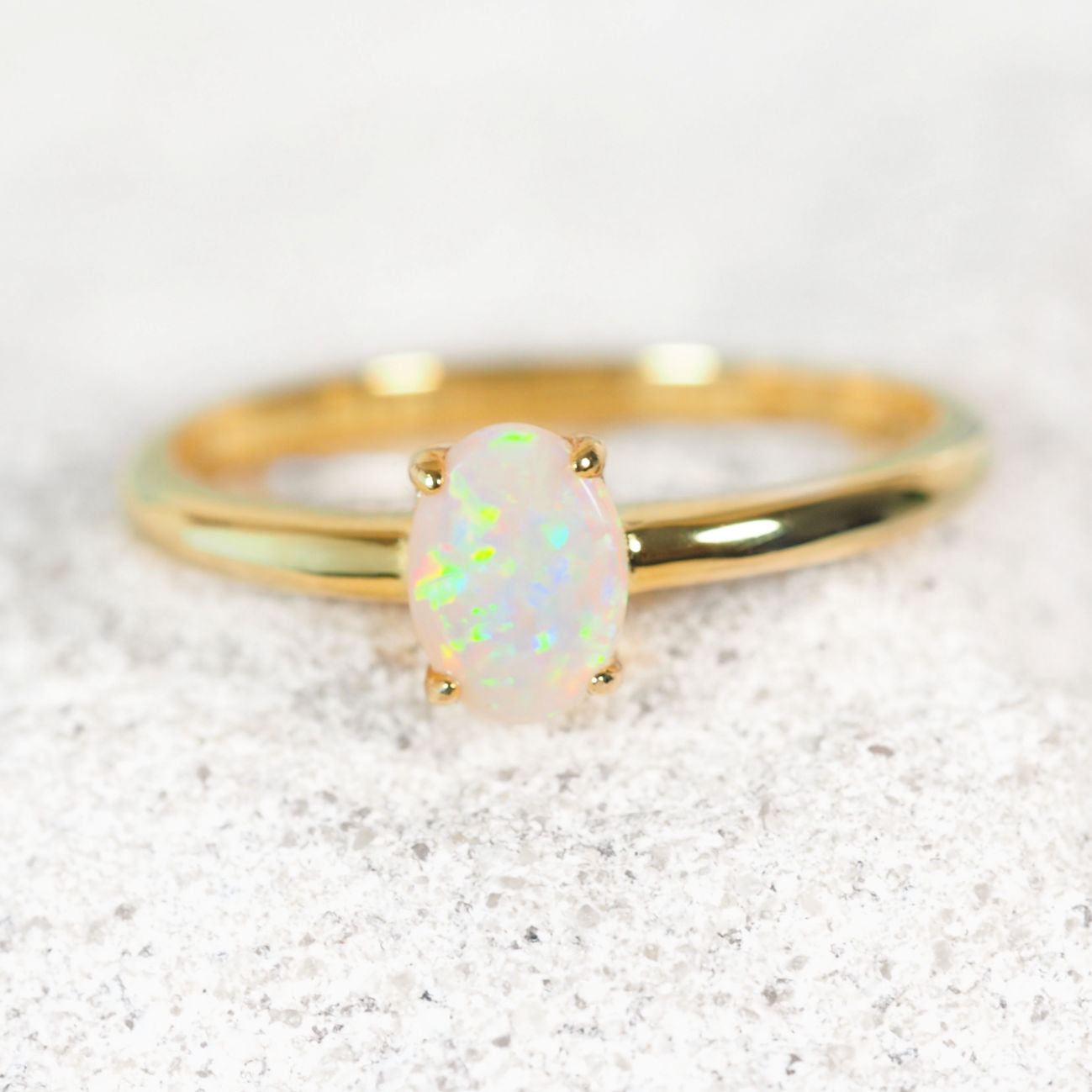 'Alina Petite' opal ring in gold plated silver with claw-set oval South Australian solid white opal in vibrant multi-coloured tones