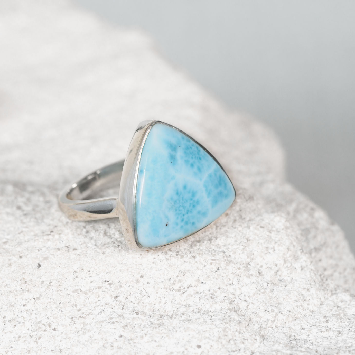 The ‘Xanthe’ silver ring with a triangular Larimar cabochon in soft blue and white marbled tones