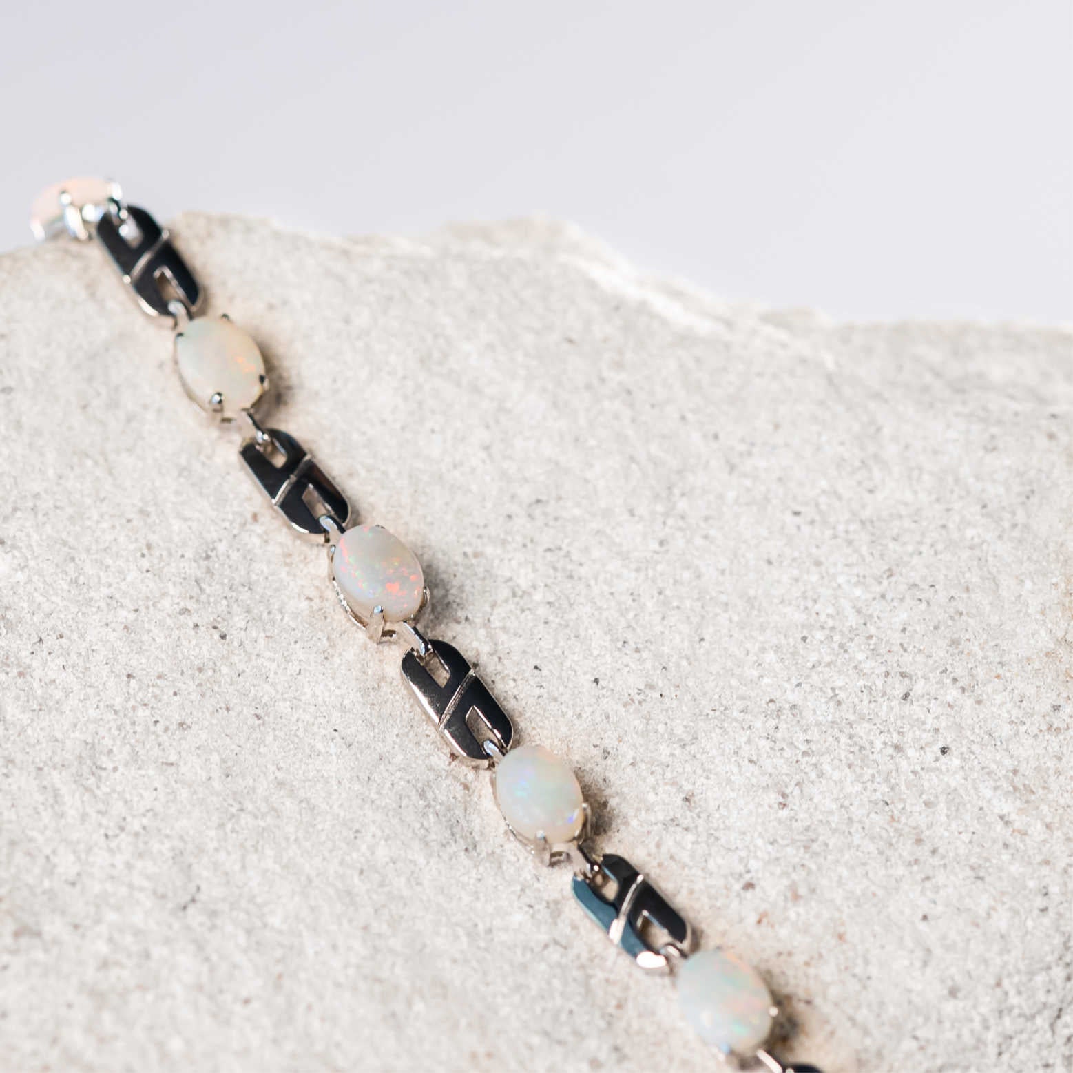 Bracelet with opal stones on a textured surface