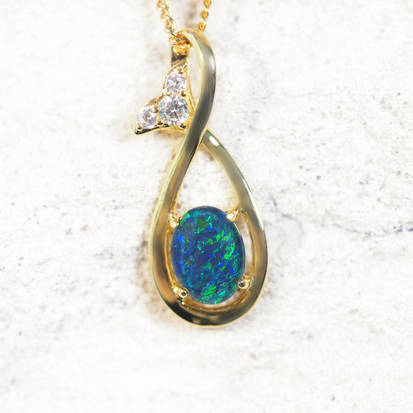 Gold-plated opal pendant with blue and green Australian triplet opal and cubic zirconias on matching chain