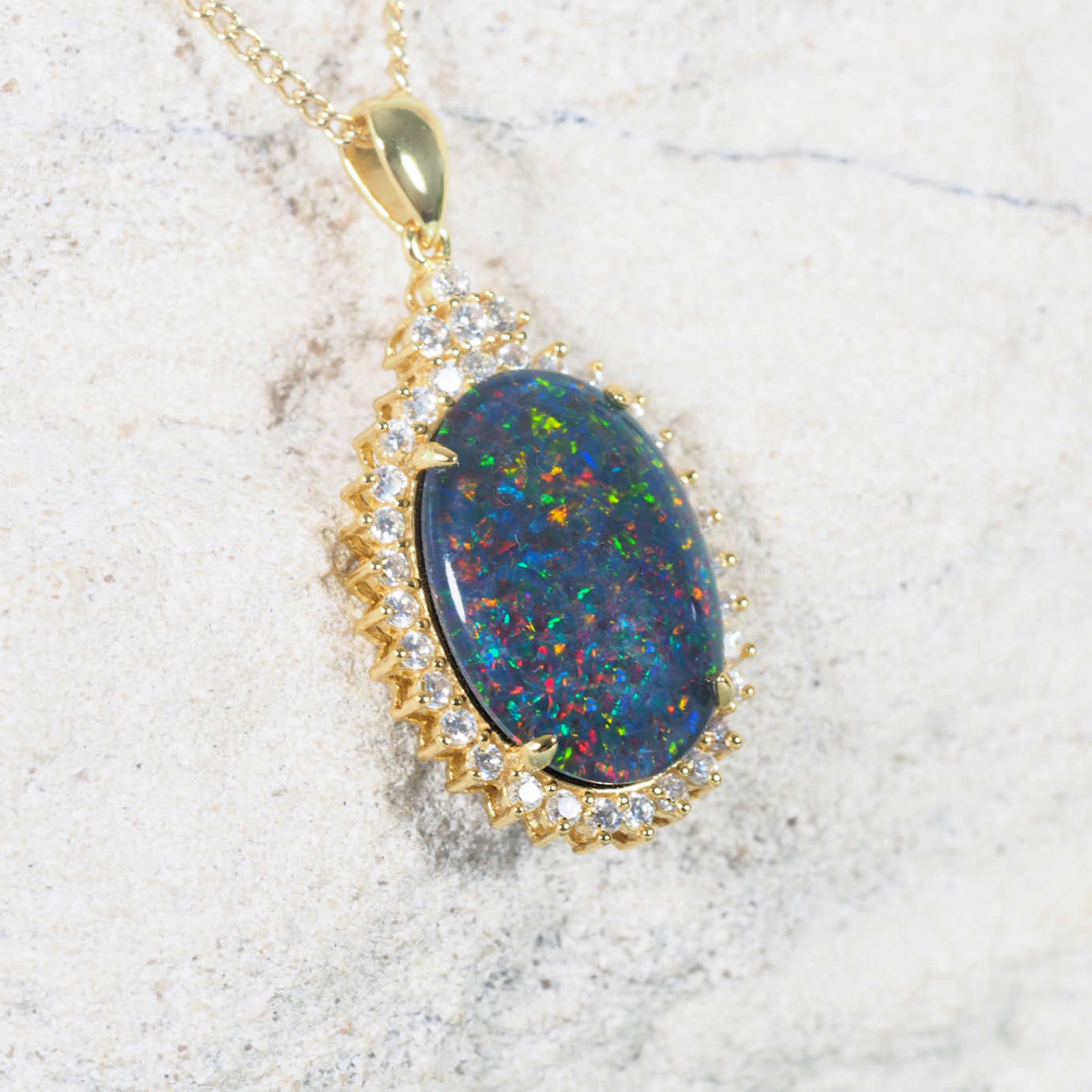 Luxury multi-coloured Australian triplet opal necklace pendant in gold-plated silver surrounded by dazzling diamantés