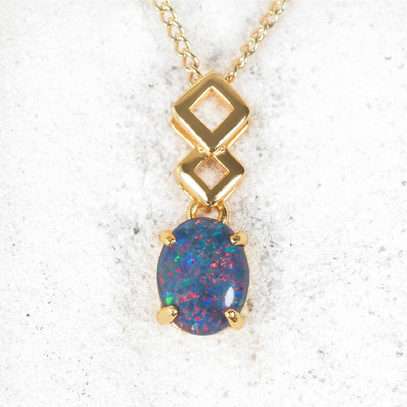 'Aria' opal pendant in polished gold-plated silver with contemporary drop design and claw-set oval Australian triplet opal