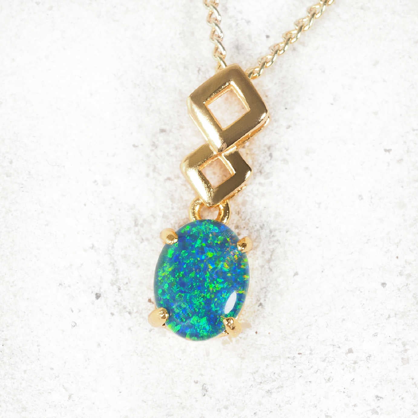 'Aria' opal pendant in gold-plated silver with contemporary drop design and claw-set oval Australian triplet opal