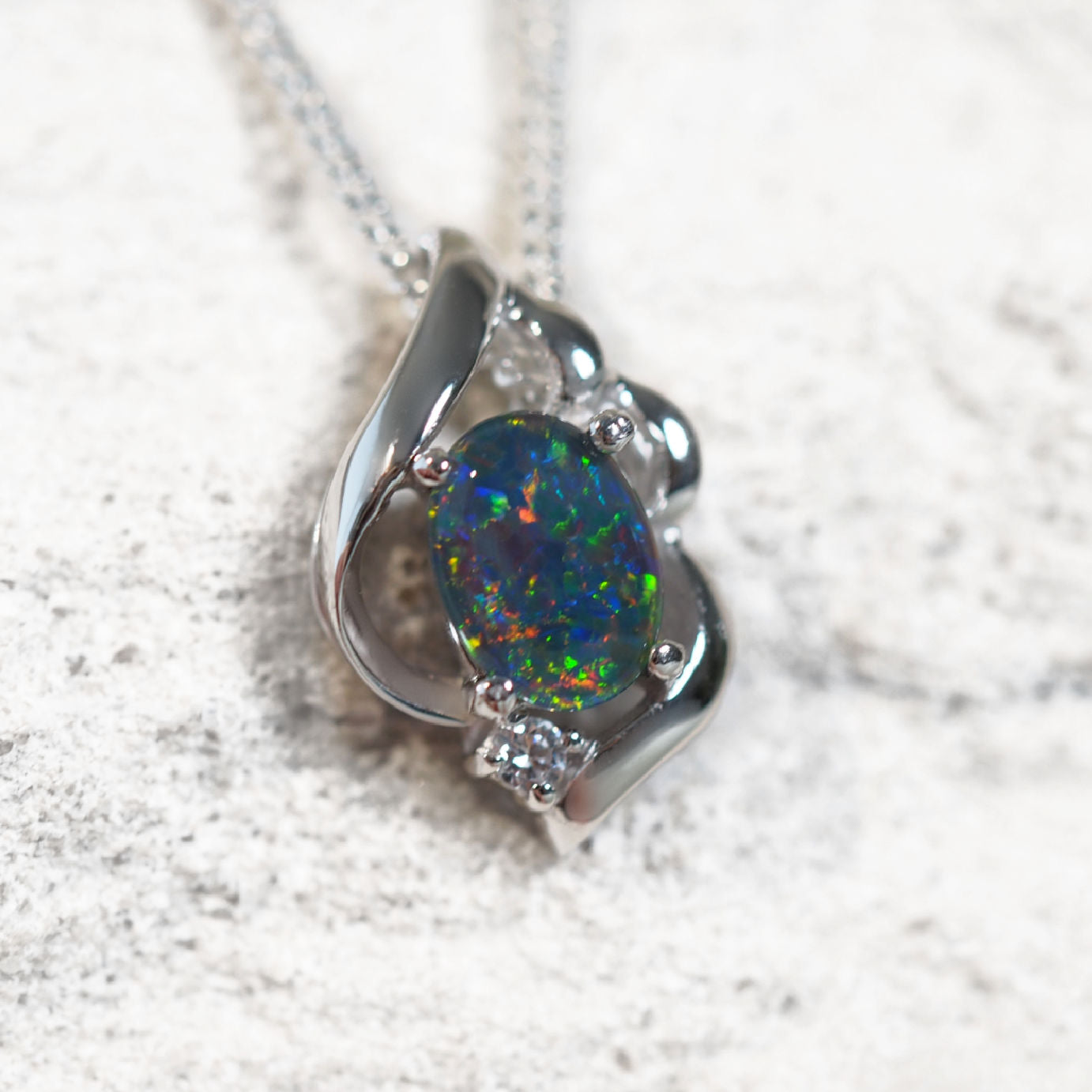 Elegant silver necklace pendant featuring multi-coloured Australian triplet opal with cubic zirconia detail – Felia design