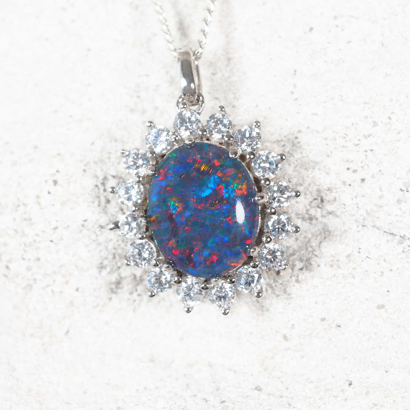 'Princess Royale' sterling silver opal pendant with oval Australian triplet opal in vivid multi-colour tones surrounded by 16 sparkling diamanté accents