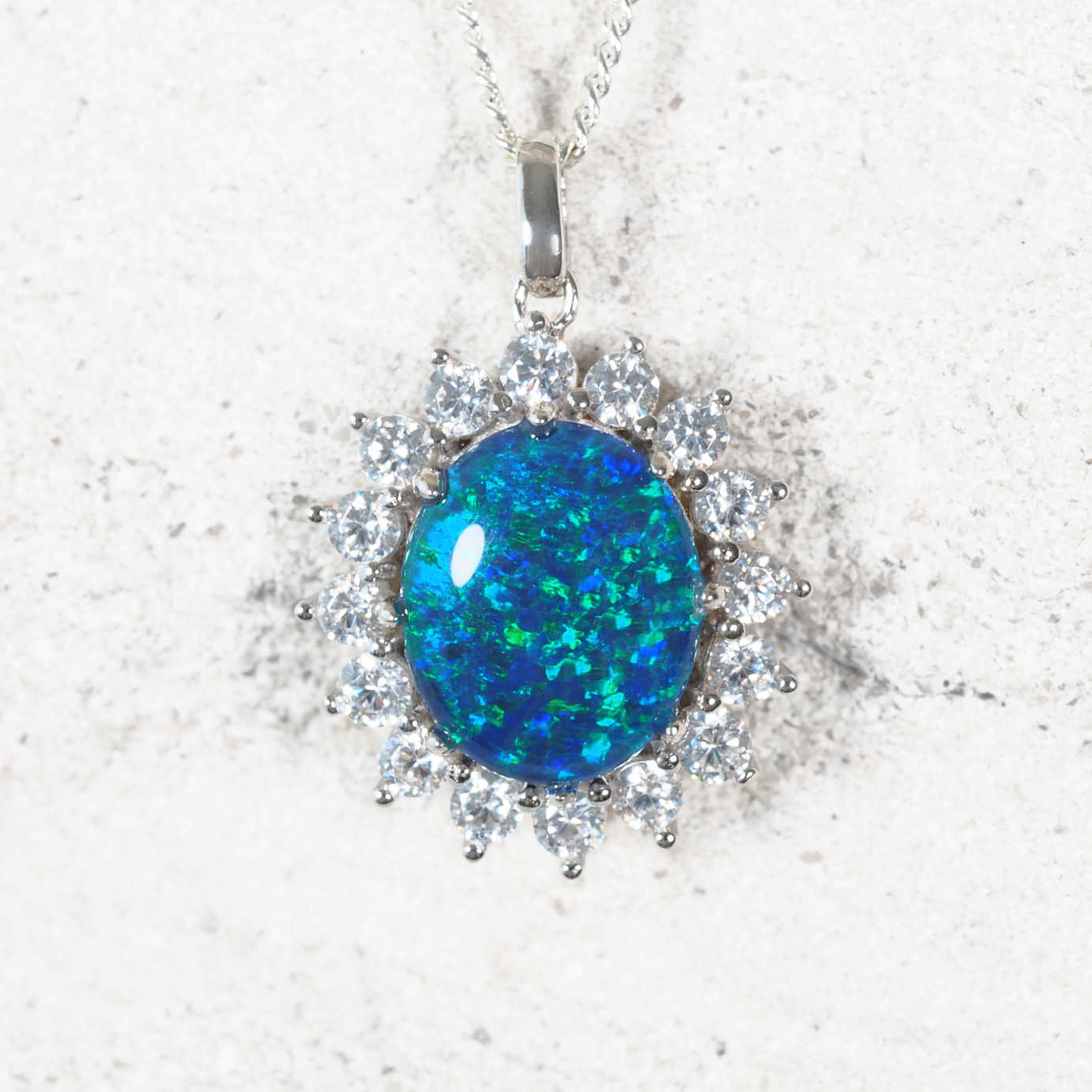'Princess Royale' sterling silver opal pendant with oval Australian triplet opal in vivid blue and green tones surrounded by 16 sparkling diamanté accents