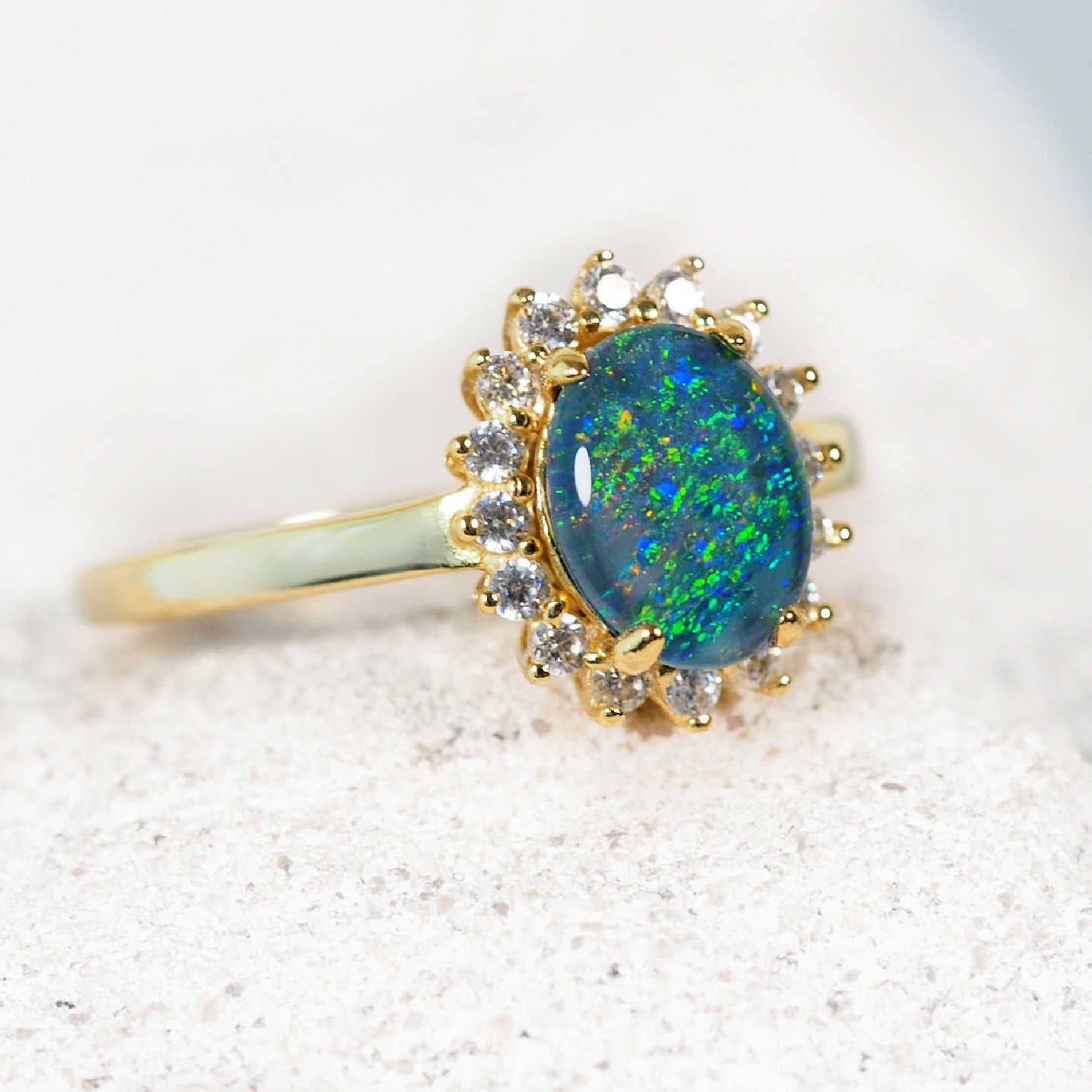 blue and green opal ring set in gold plated silver with 16 cubic zirconias