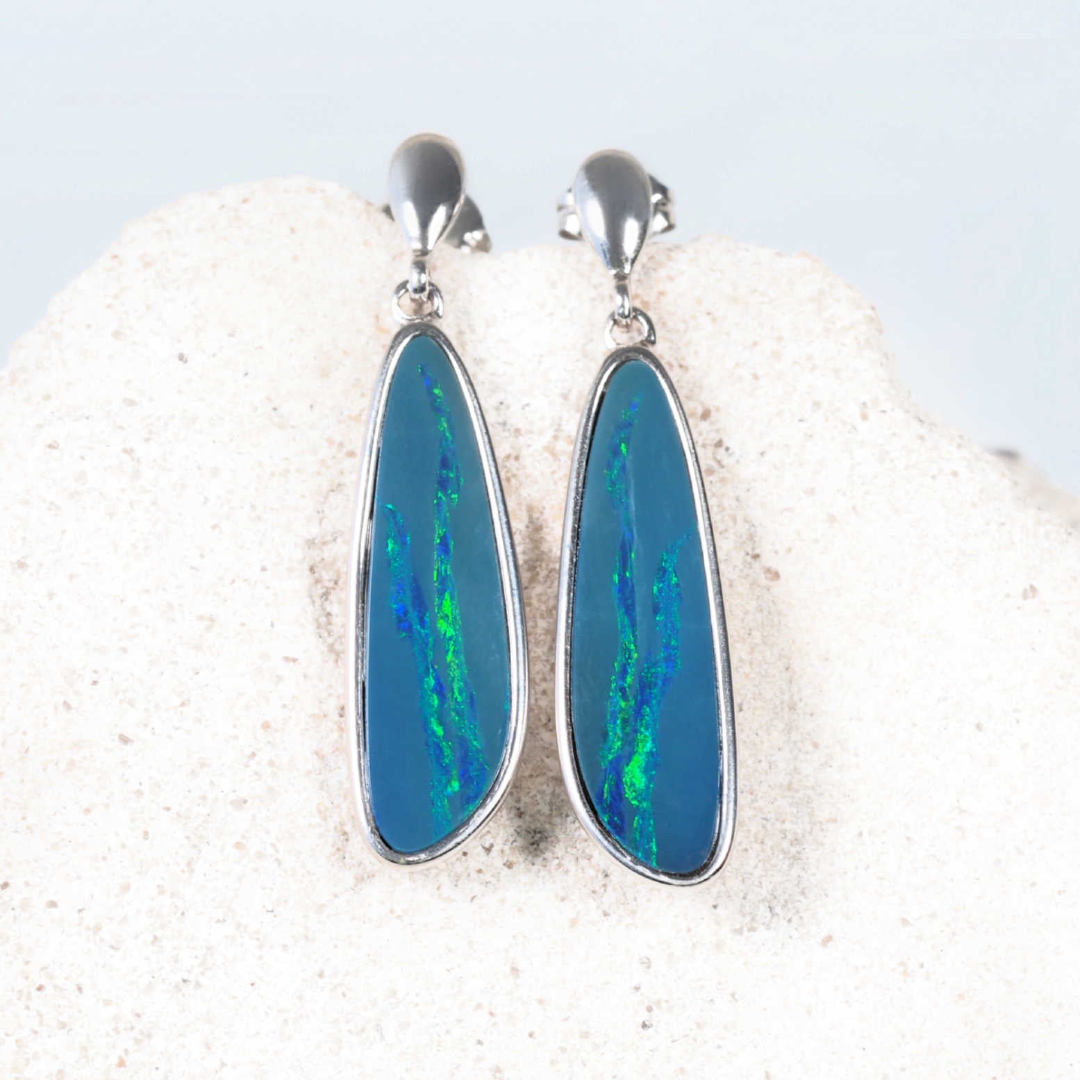 'Alira’ stud drop opal earrings showing bezel-set opals with neon-green and electric blue flashes