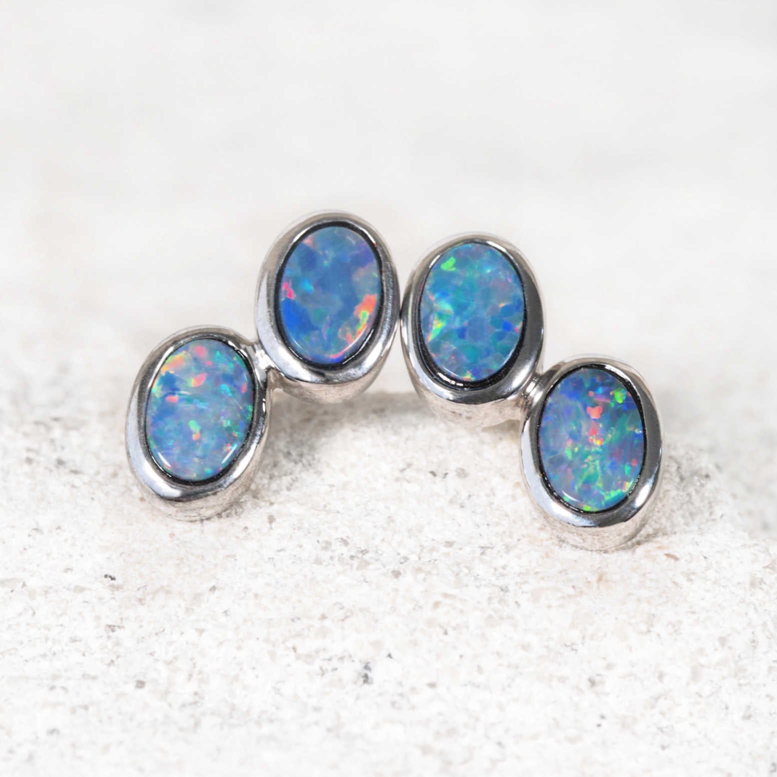 Oval-shaped doublet opal earrings set in polished sterling silver