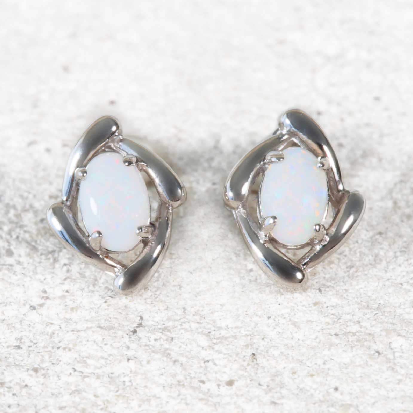 Elegant oval-shaped solid white opal stud earrings in sterling silver setting – ‘Kenzo’ design