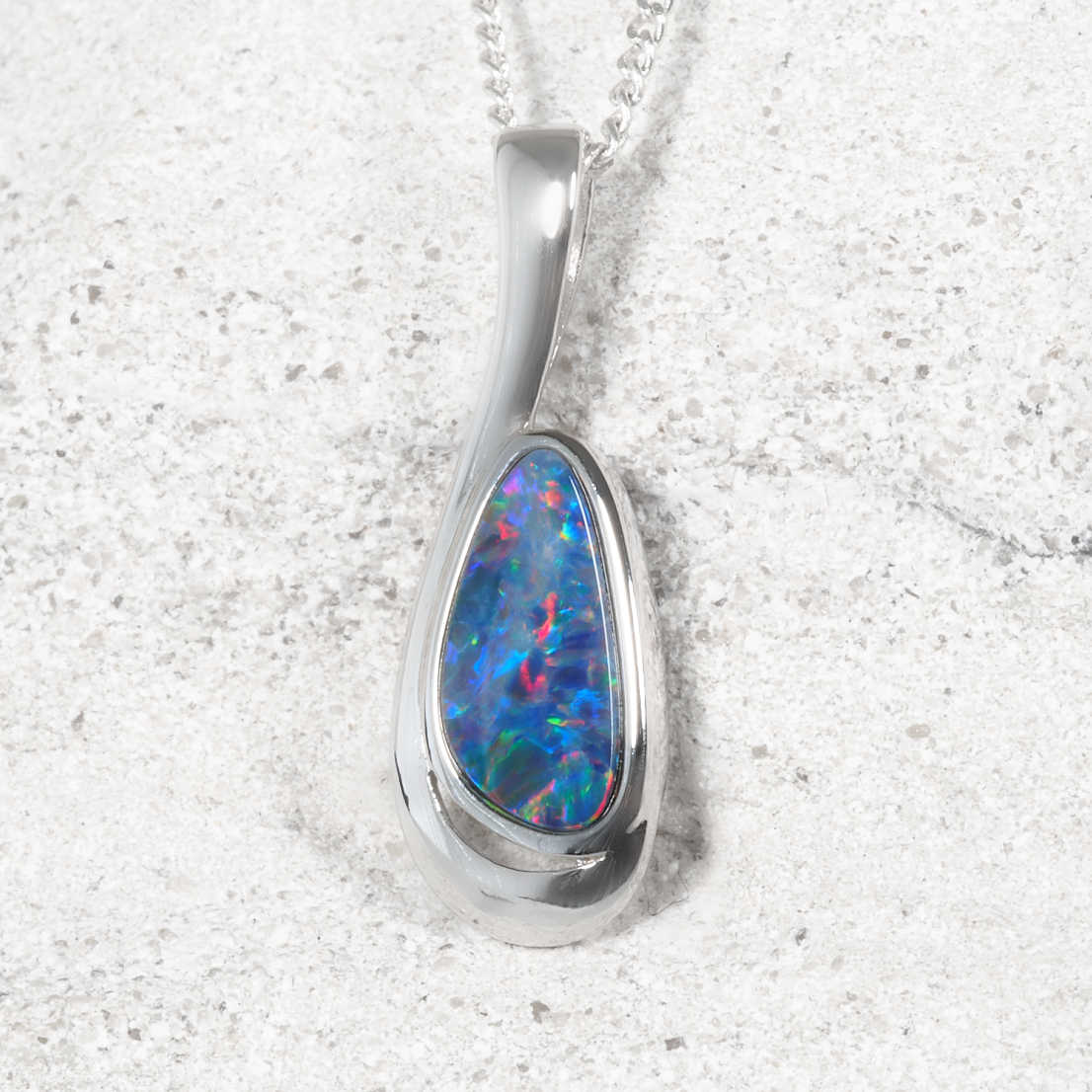Sterling silver Australian opal pendant featuring a colourful natural opal doublet in a modern flowing design