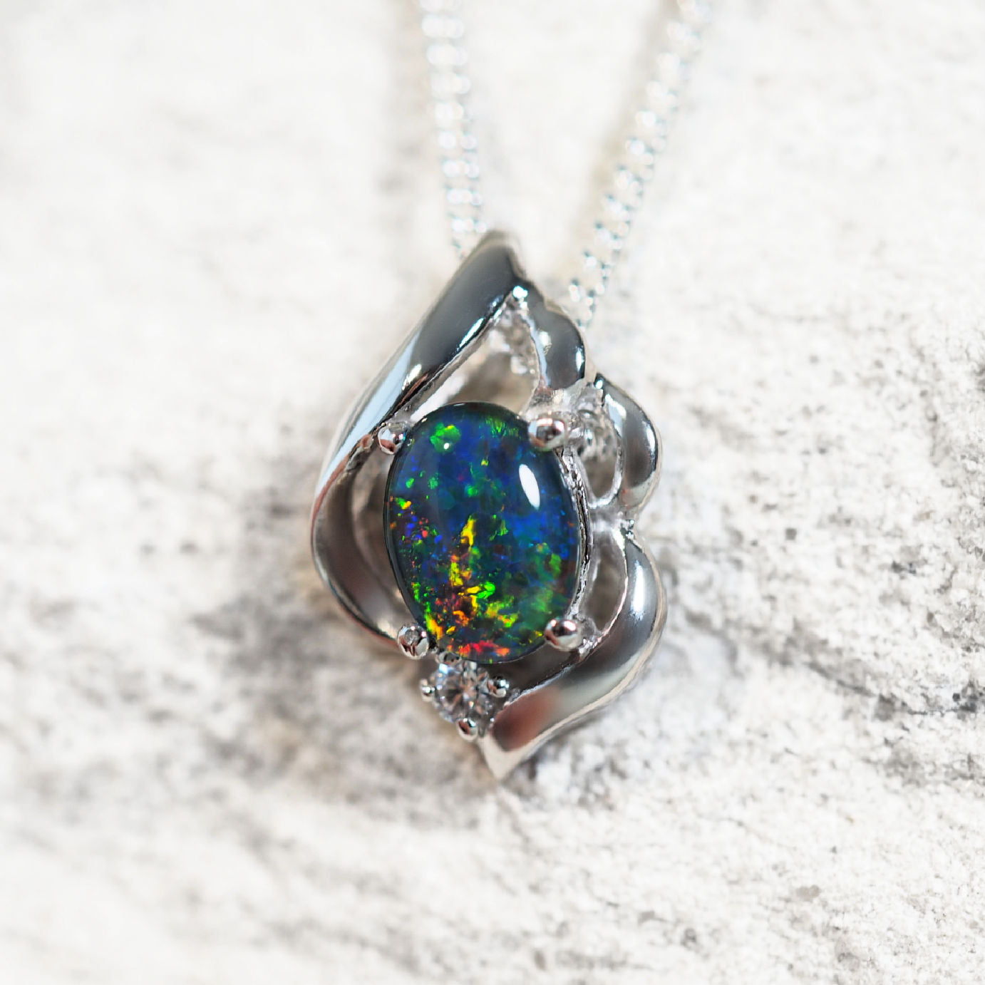 Felia opal pendant in sterling silver with claw-set oval Australian triplet opal and sparkling cubic zirconia accent