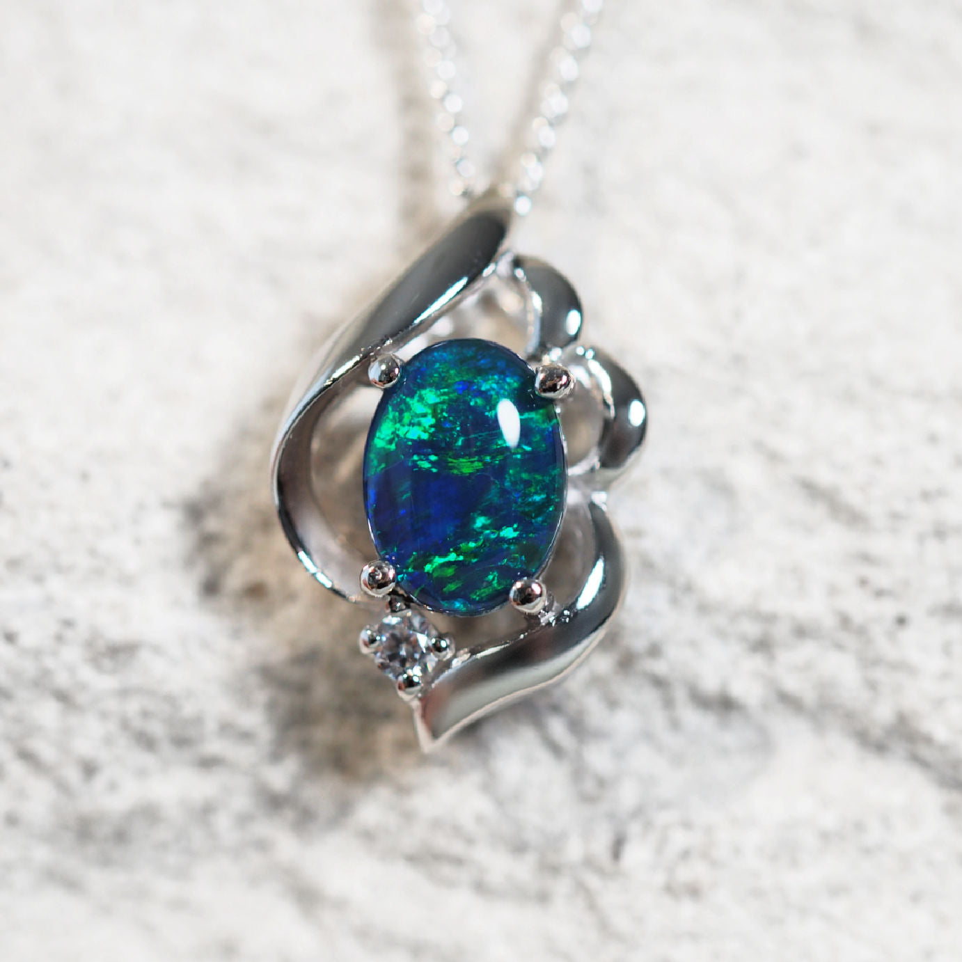 'Felia Blue' opal pendant in sterling silver with claw-set oval Australian triplet opal and sparkling cubic zirconia accent