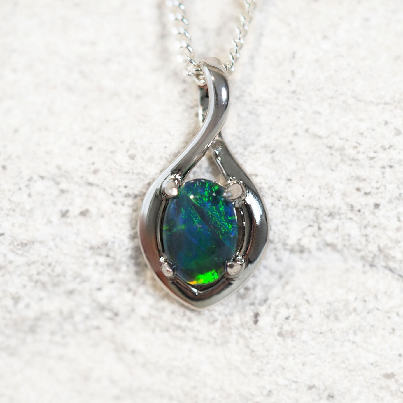 'Lira Blue' opal pendant in sterling silver with claw-set oval Australian triplet opal in vibrant blue and green tones