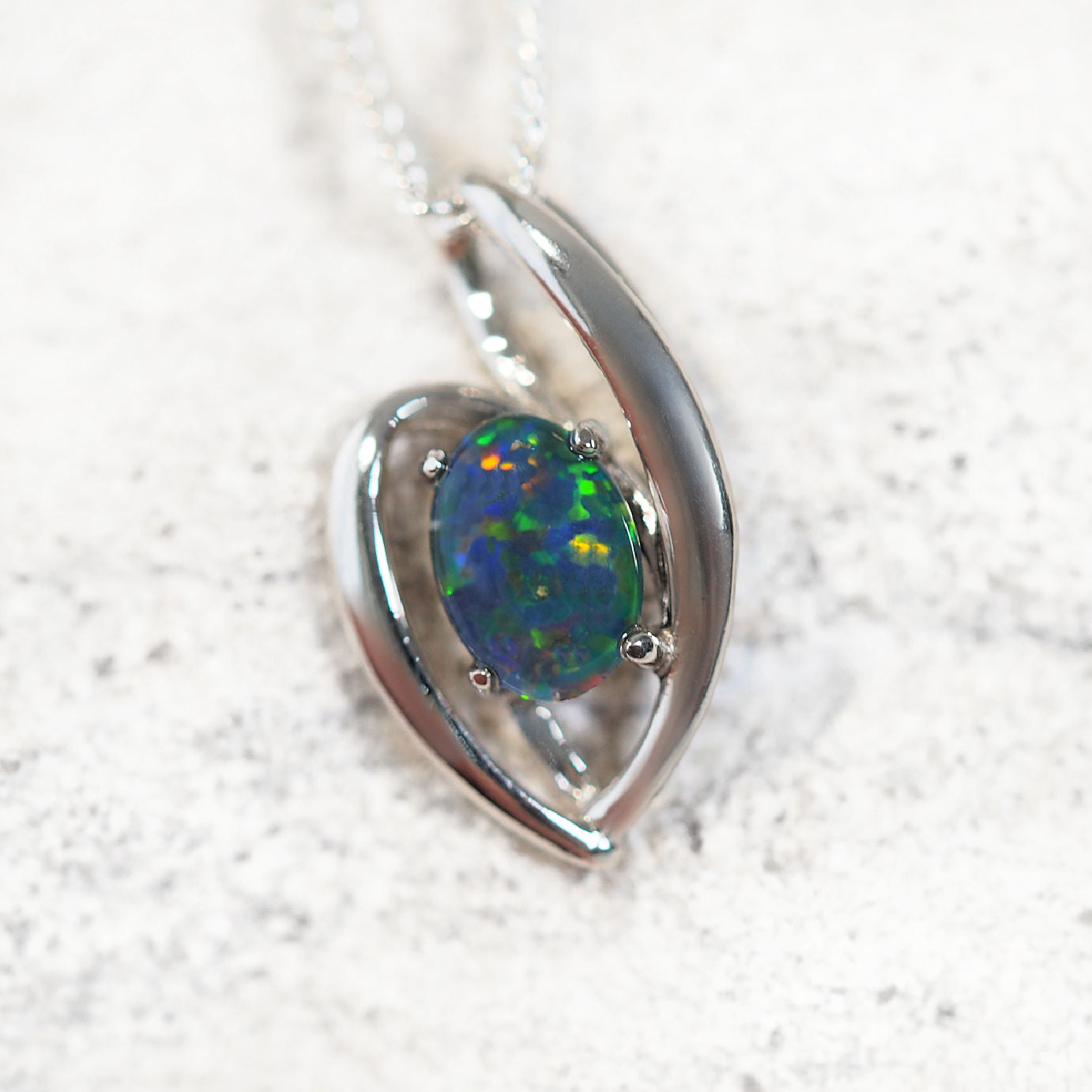'Alessia' opal pendant in sterling silver with slide design and claw-set oval Australian triplet opal in multi-colour tones