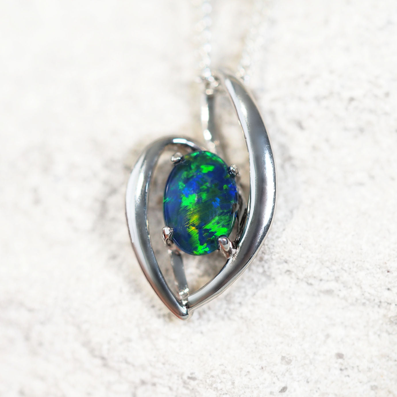 'Alessia Blue' opal pendant in sterling silver with slide design and claw-set oval Australian triplet opal in vivid blue and green tones