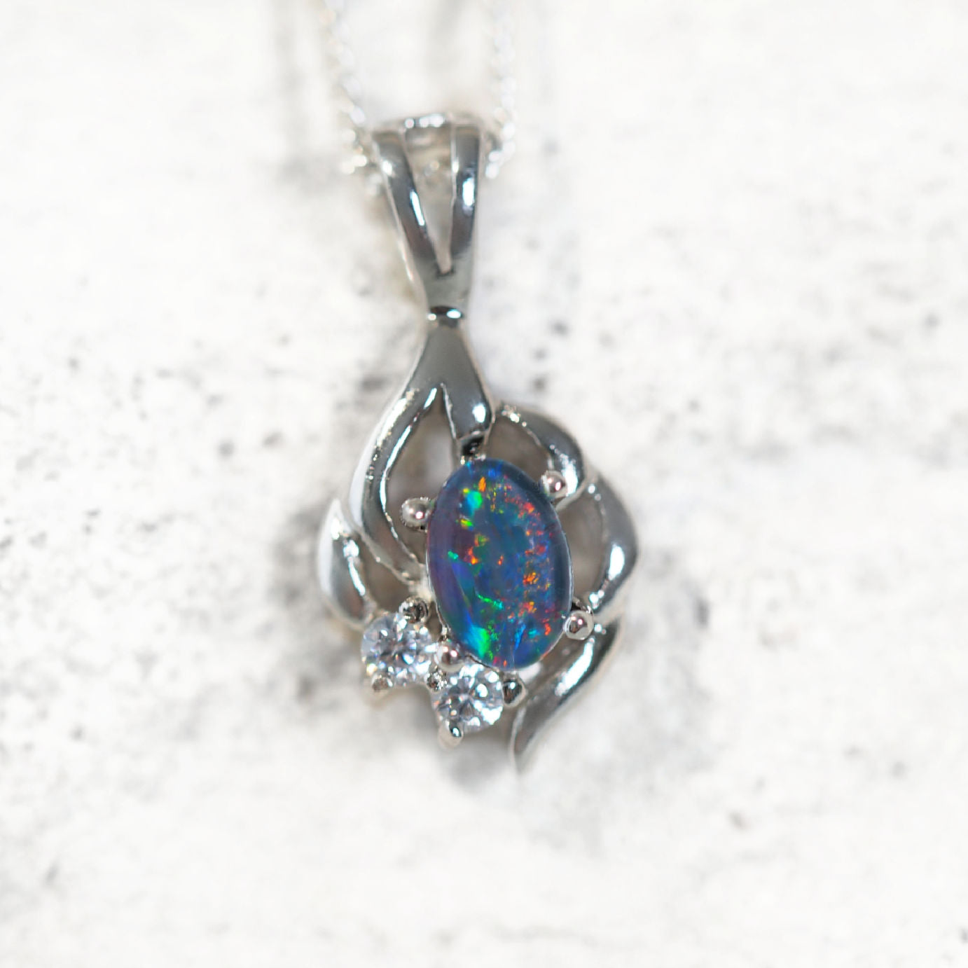 Tamia opal pendant in sterling silver with intricate design, claw-set oval Australian triplet opal and two sparkling diamantés