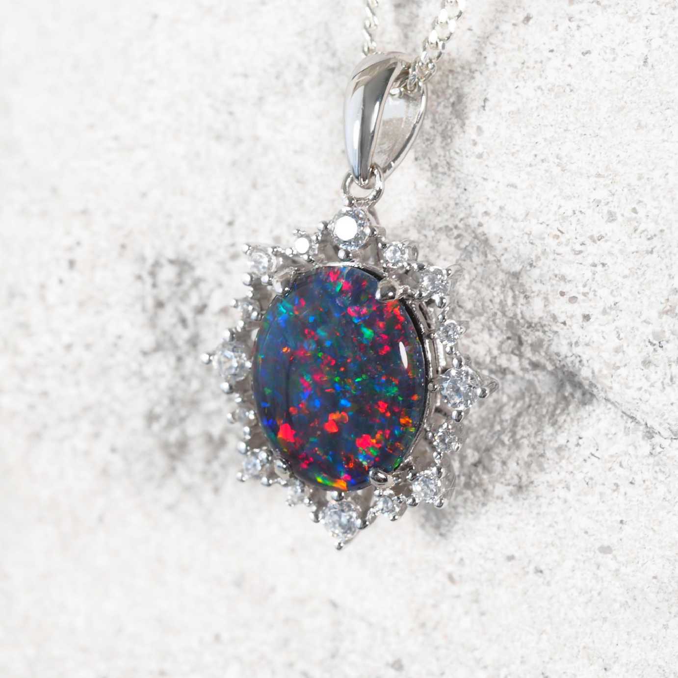 Elegant sterling silver opal necklace pendant featuring multi-coloured Australian triplet opal surrounded by 16 cubic zirconias