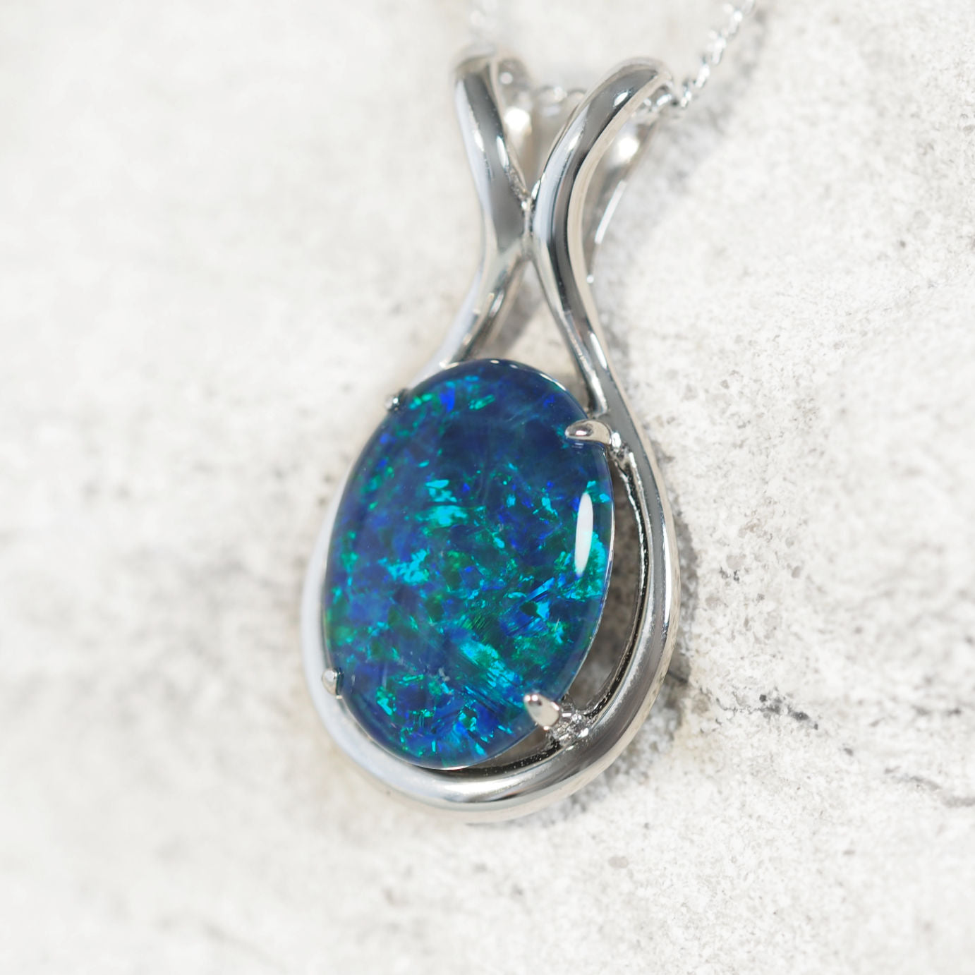 Sterling silver opal necklace pendant featuring claw-set blue and green Australian triplet opal with natural play-of-colour