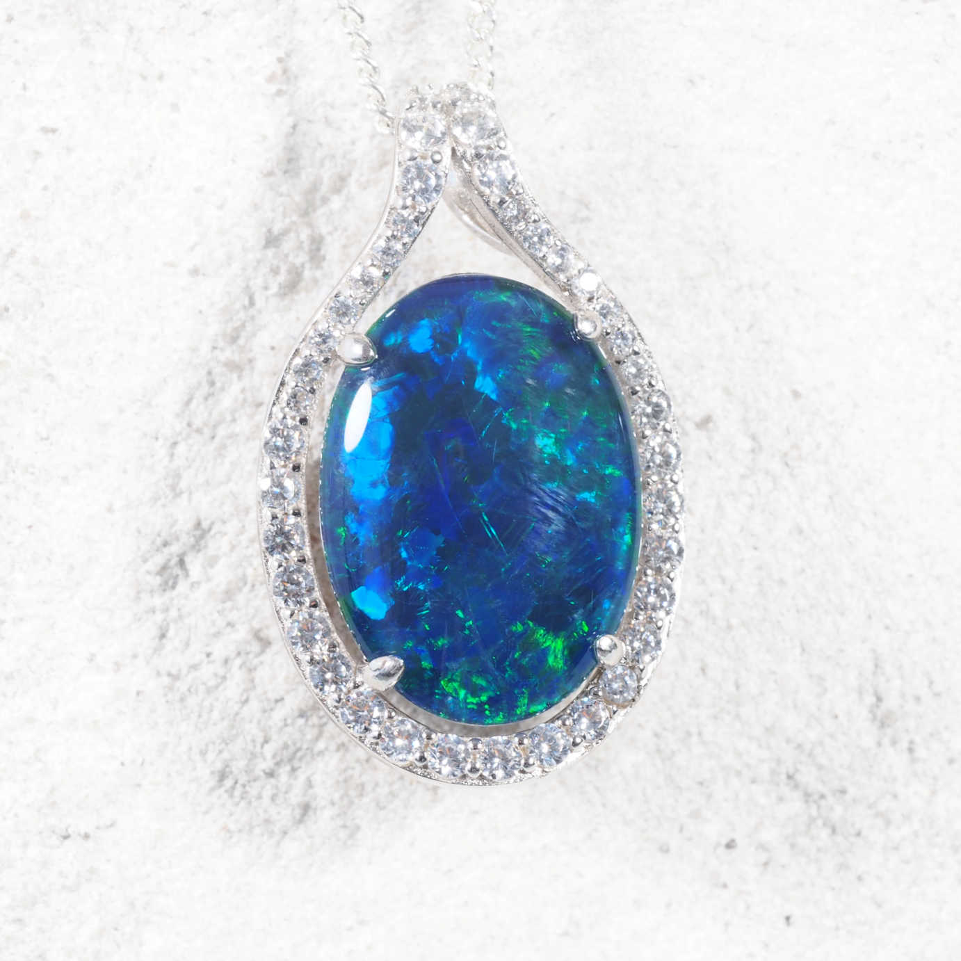'Dianna Blue' sterling silver opal pendant with oval blue-green Australian triplet opal surrounded by a dazzling halo of 40 sparkling diamantés