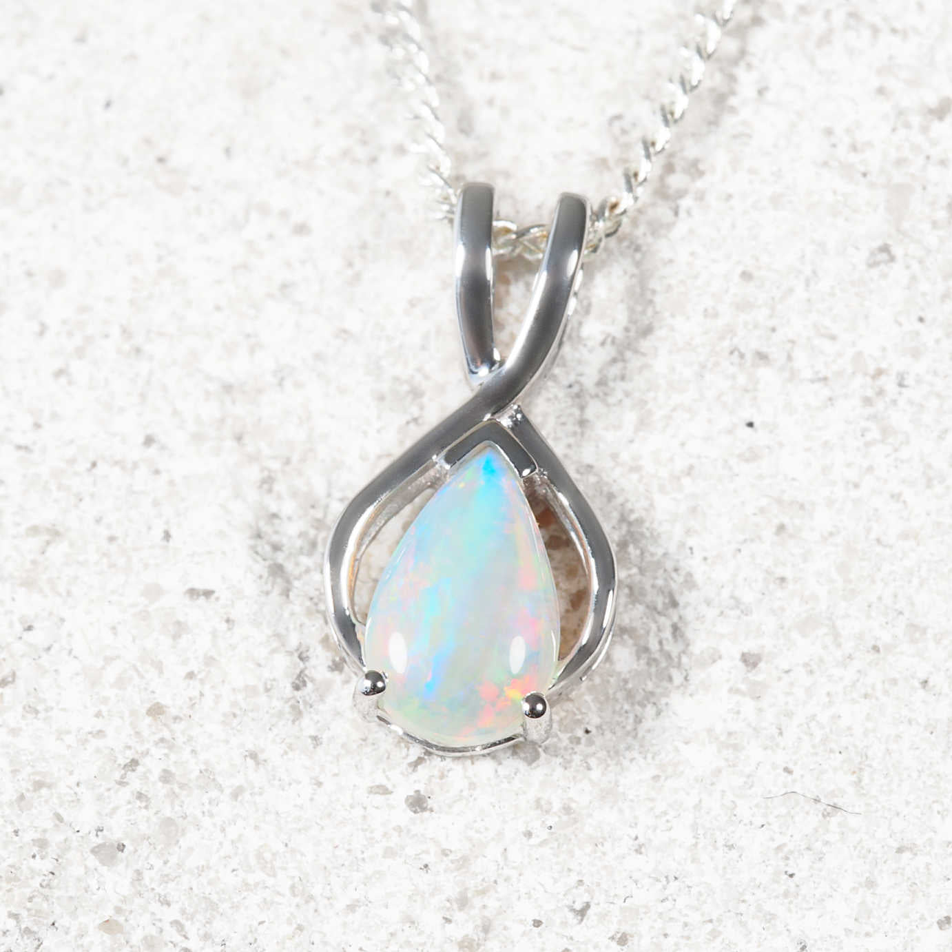 Colourful crystal opal pendant set in white gold