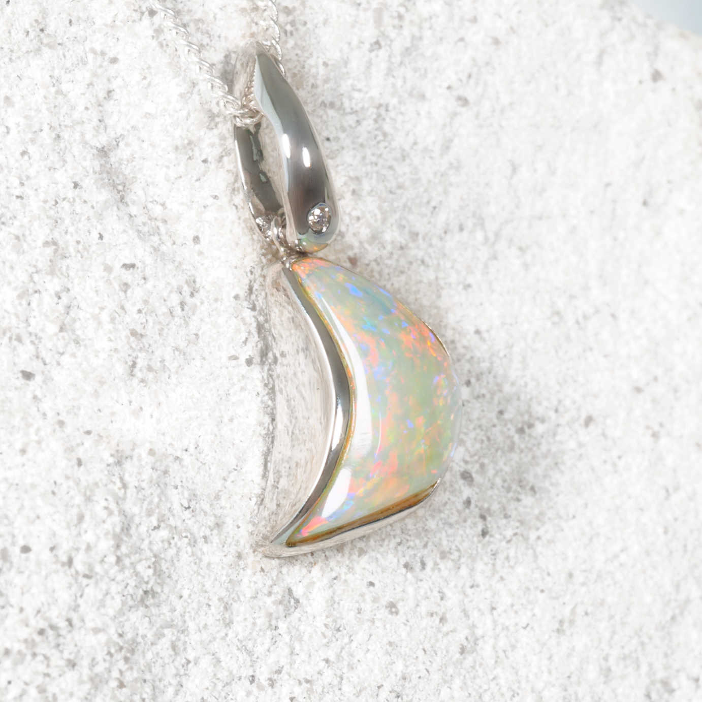 Elegant 14ct white gold bezel-set opal pendant with unique-shaped solid white opal and white diamond