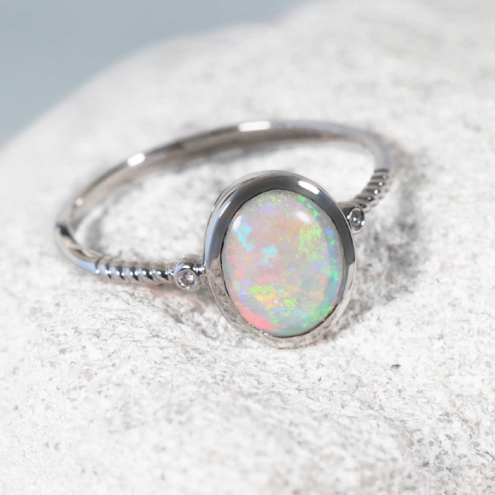 White gold opal ring set with a crystal opal