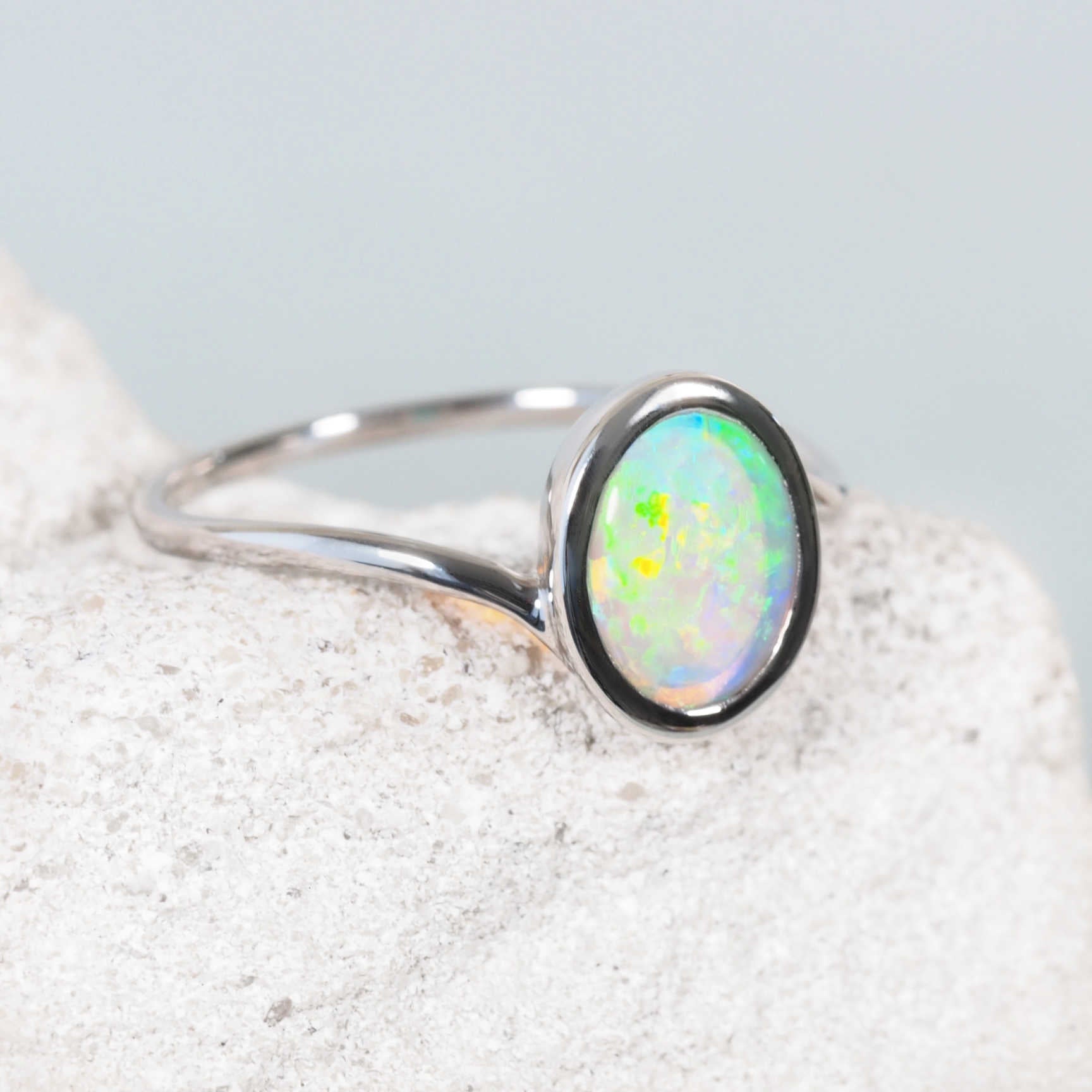 Australian crystal opal ring with green and blue flashes in white gold