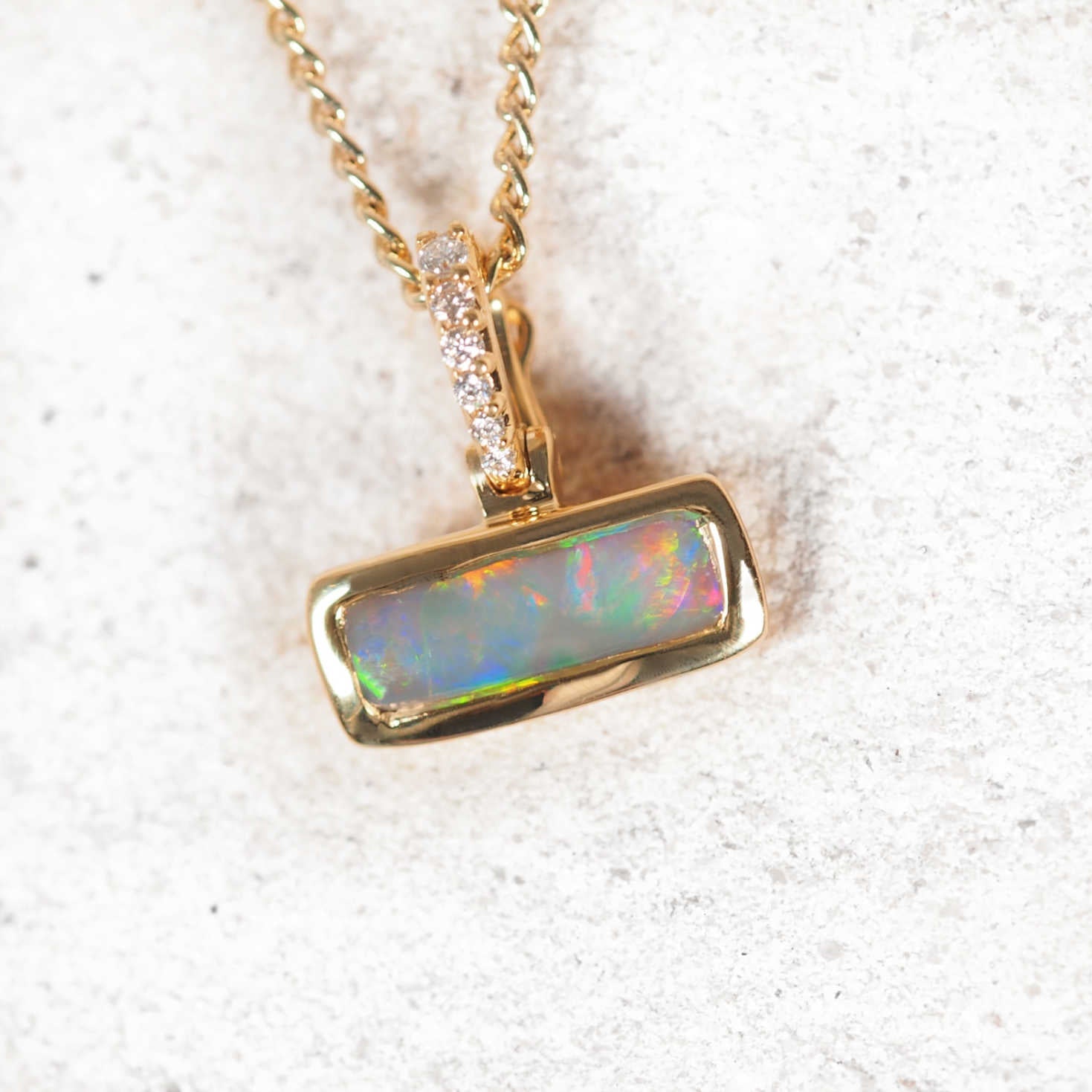 Adelise 18ct gold black opal pendant with vivid multi-colour play and six diamond accents