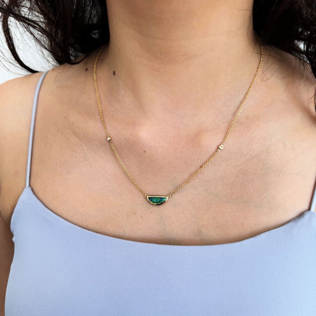 a model wears the gold opal necklace