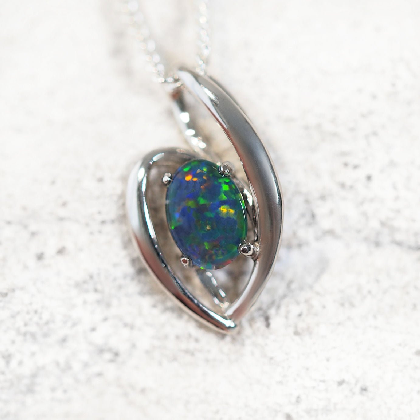 'Alessia' opal pendant in sterling silver with slide design and claw-set oval Australian triplet opal in multi-colour tones