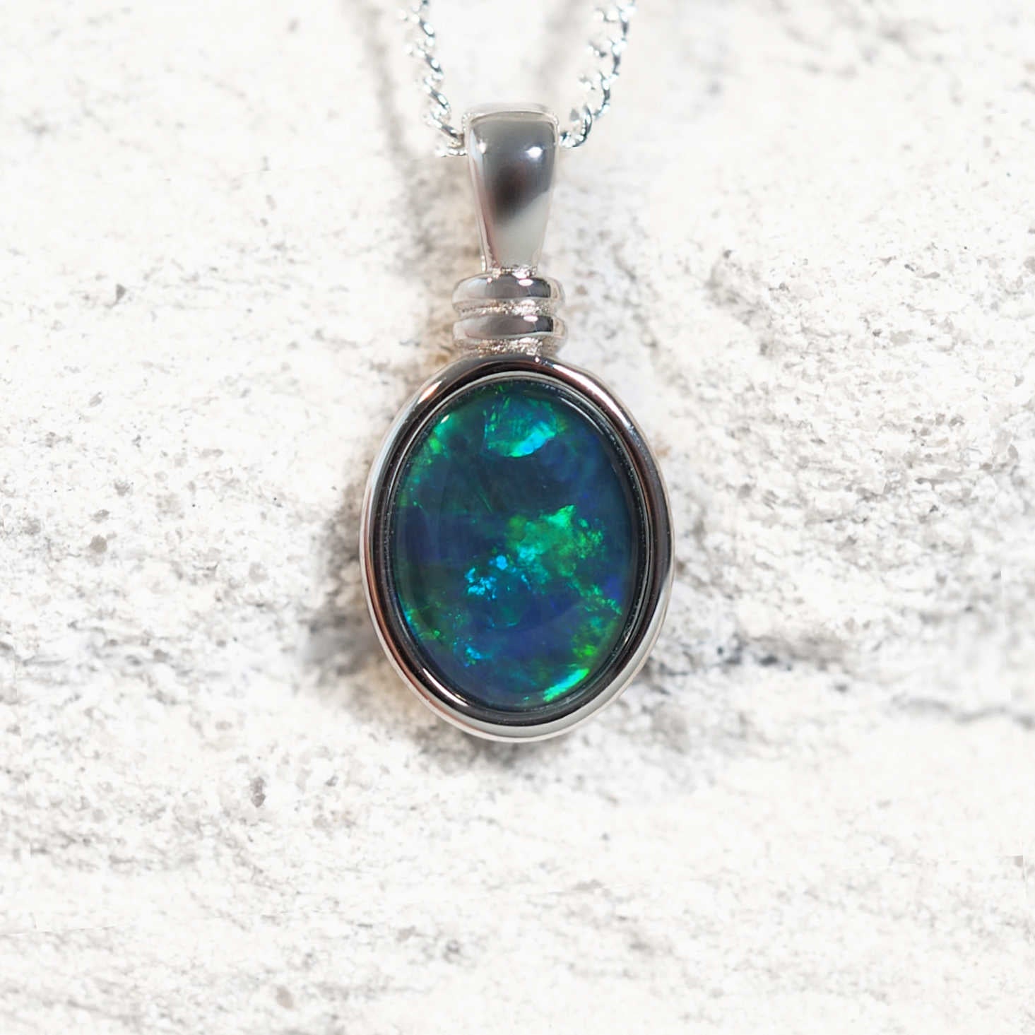'Alice Blue' opal pendant in sterling silver with claw-set oval Australian triplet opal in vivid blue and green tones