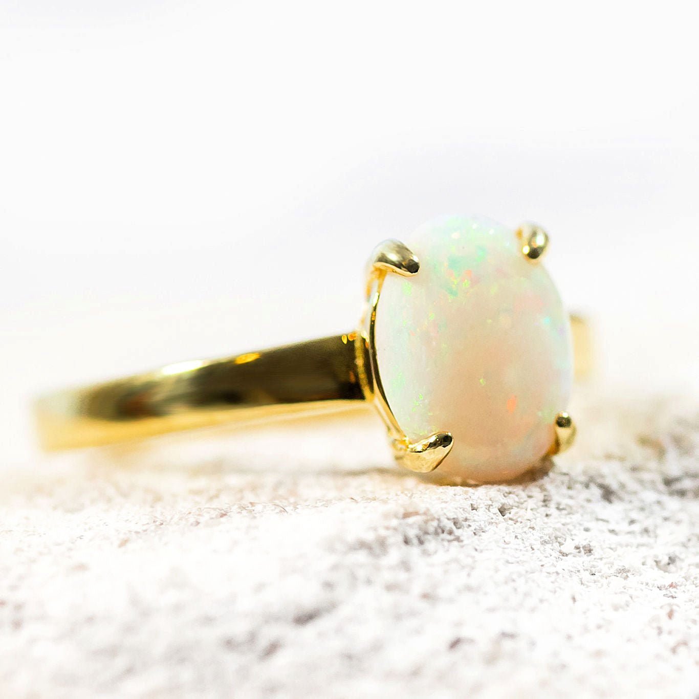 white opal classic design opal ring set in gold plated silver