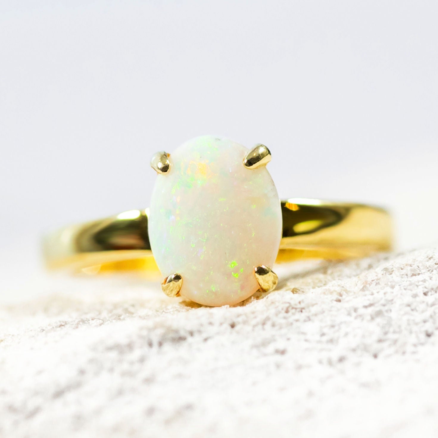 colourful white opal ring set in gold plated silver in a classic design