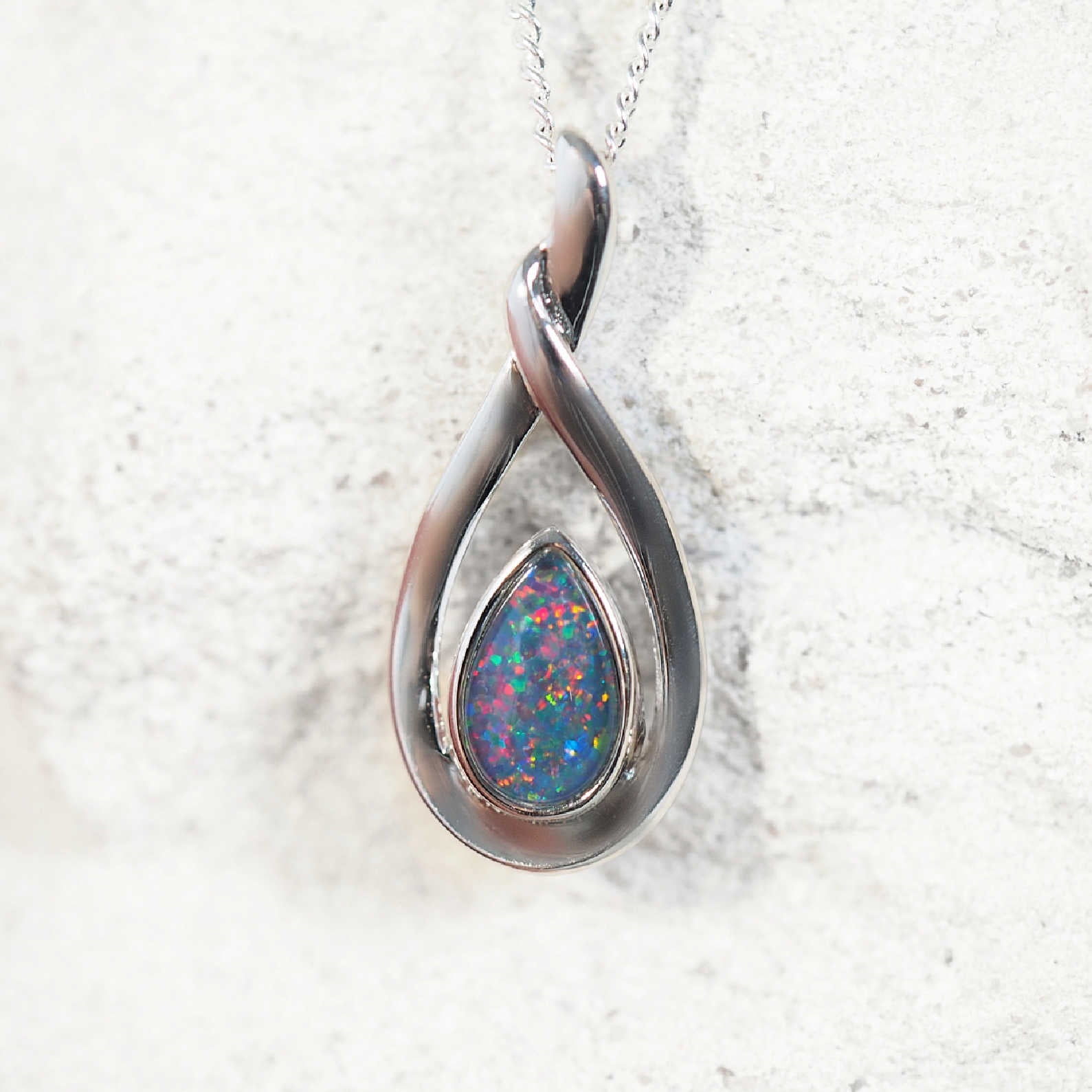 'Alison' opal pendant in sterling silver with elegant twist design and bezel-set teardrop Australian triplet opal in vibrant multi-coloured tones