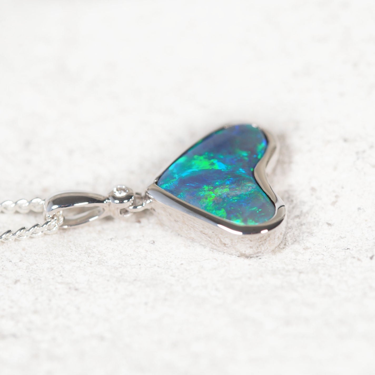 Elegant Australian black opal pendant with bezel-set heart-shaped opal