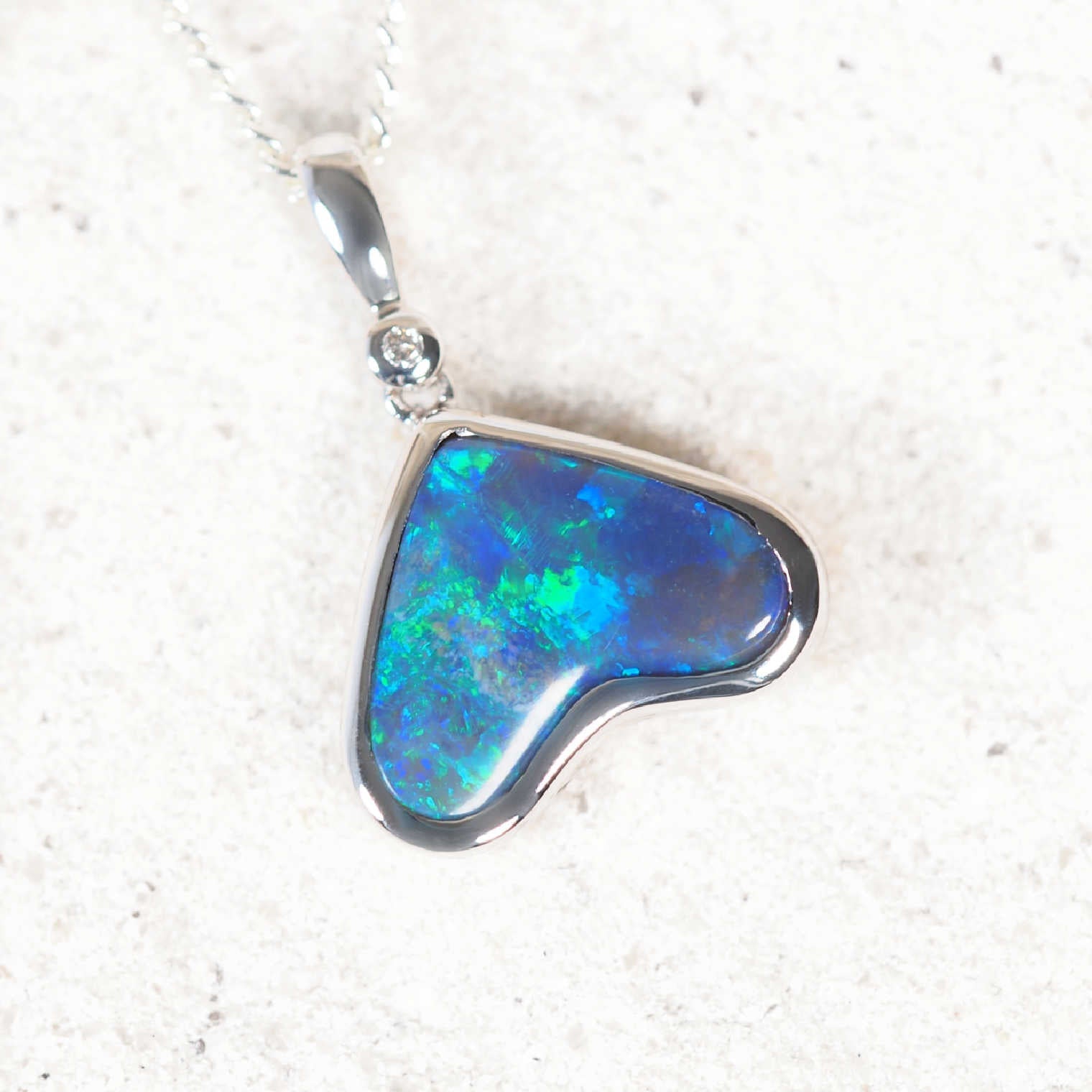 Heart-shaped Australian black opal pendant with blue-green play-of-colour