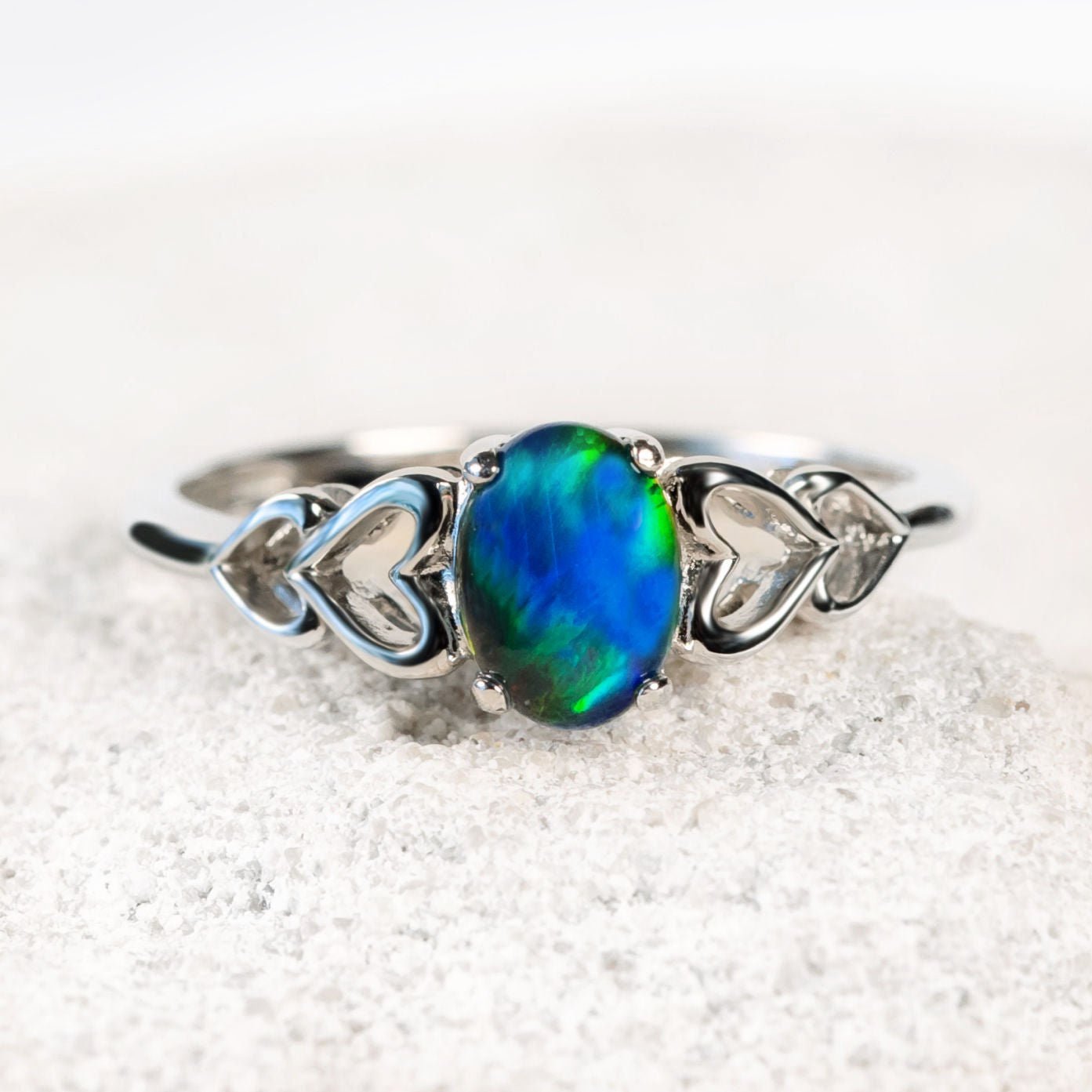 heart design opal ring with a blue-green stone
