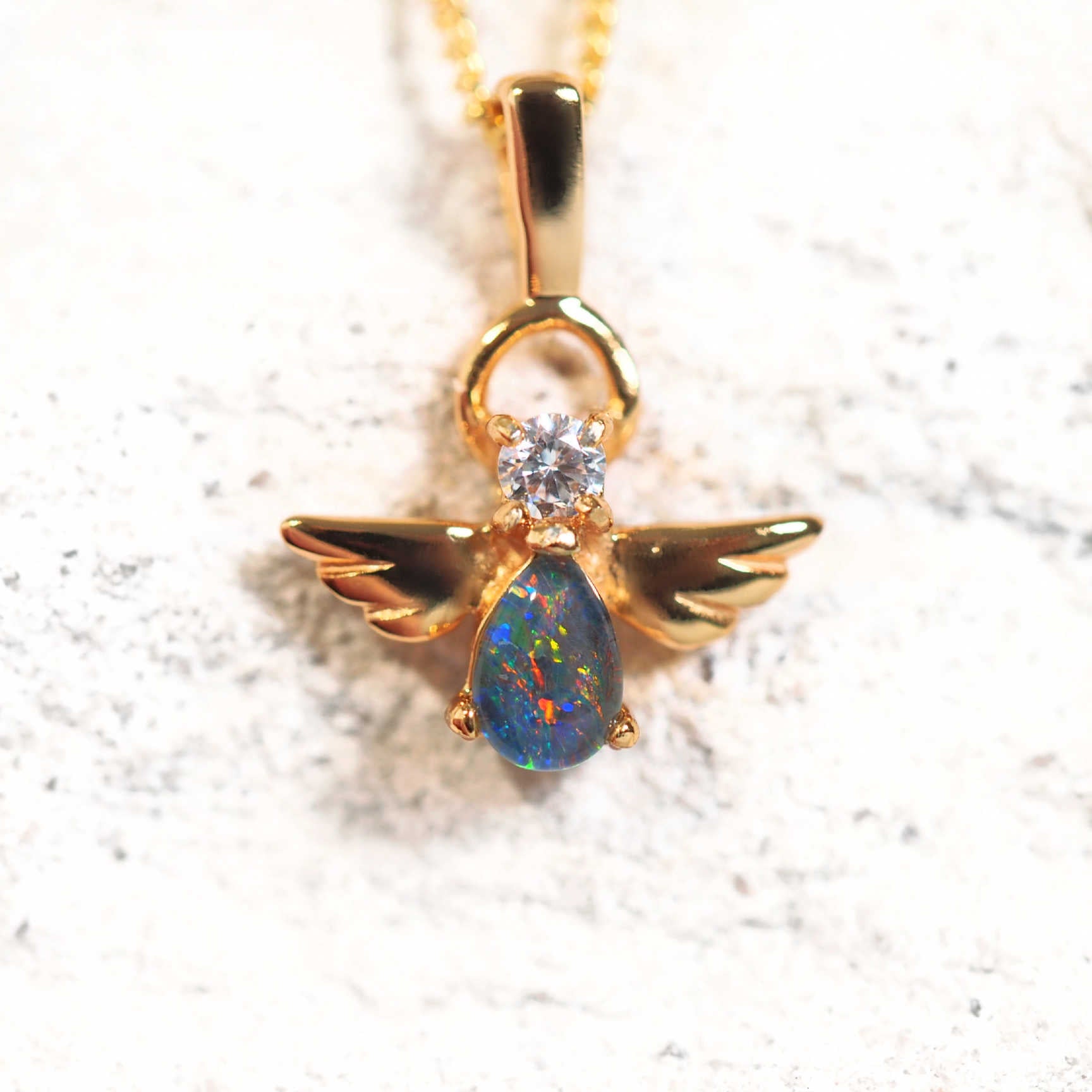 Gold-plated silver winged angel opal pendant with multi-coloured teardrop opal and cubic zirconia.
