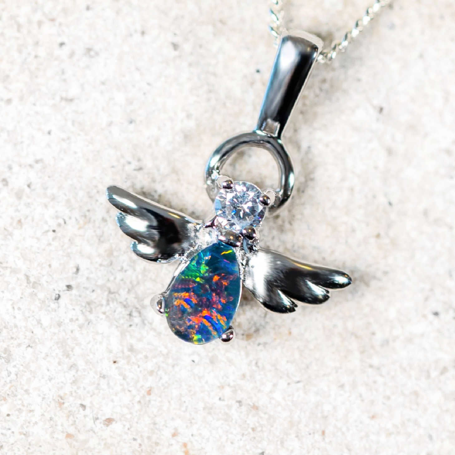 angel design opal pendant with a sparkling diamante