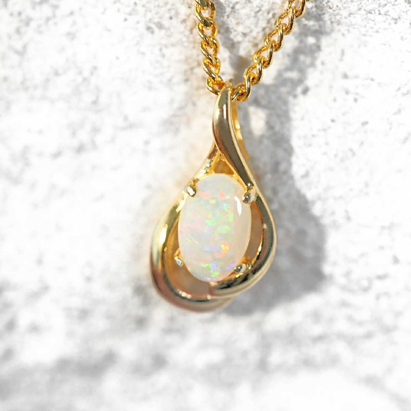 Crystal opal pendant set in yellow gold