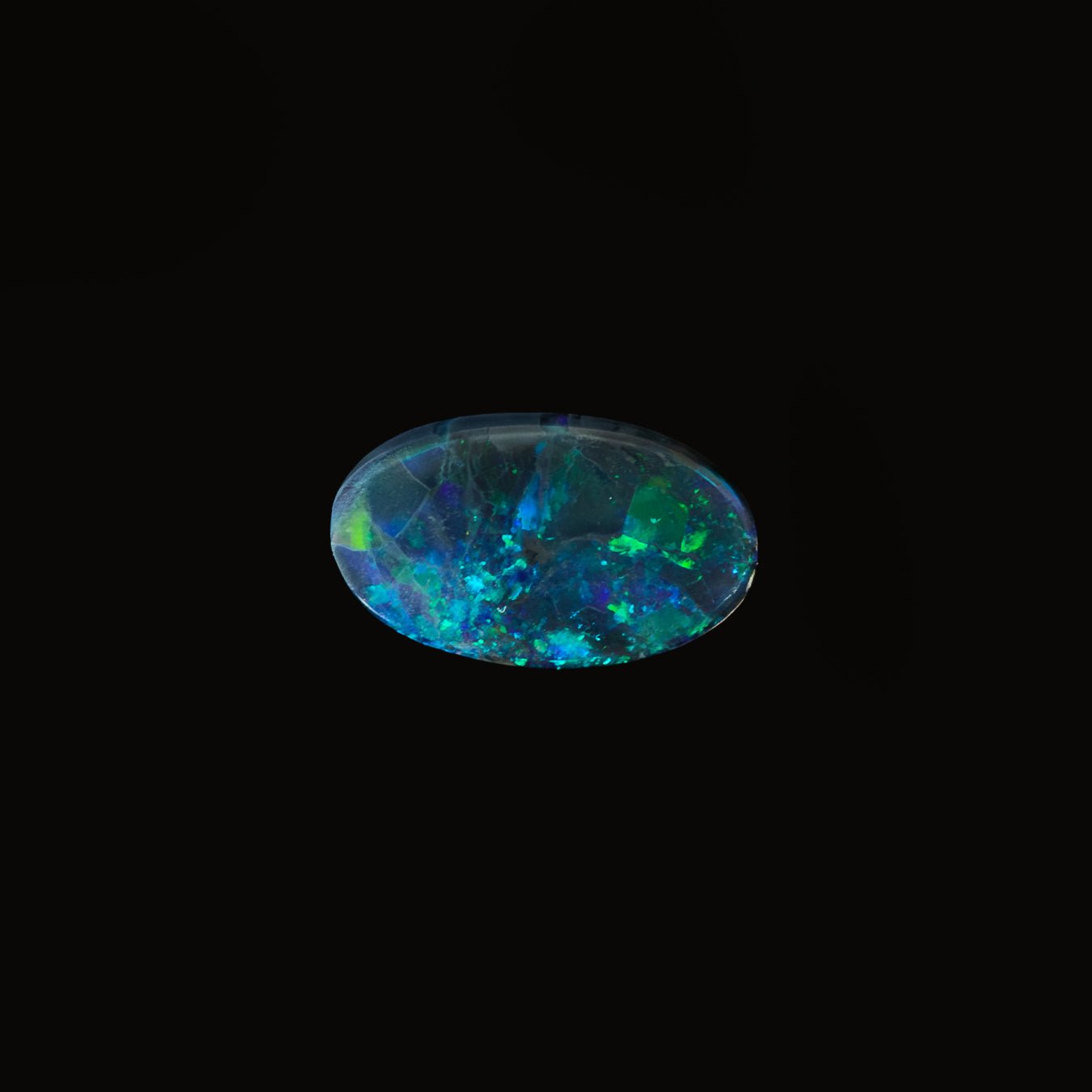 Oval Lightning Ridge black opal with vivid green speckles