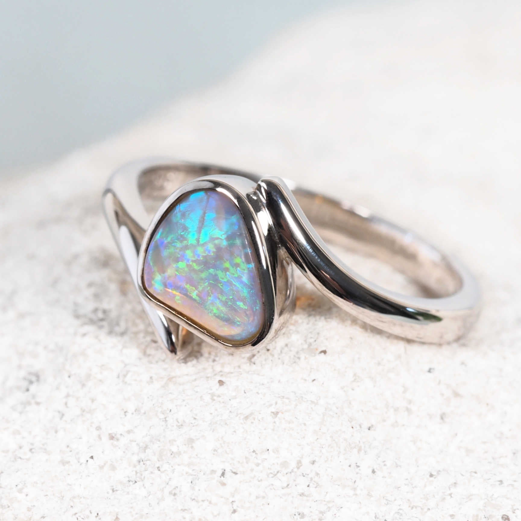Contemporary design opal ring featuring a triangular cut opal