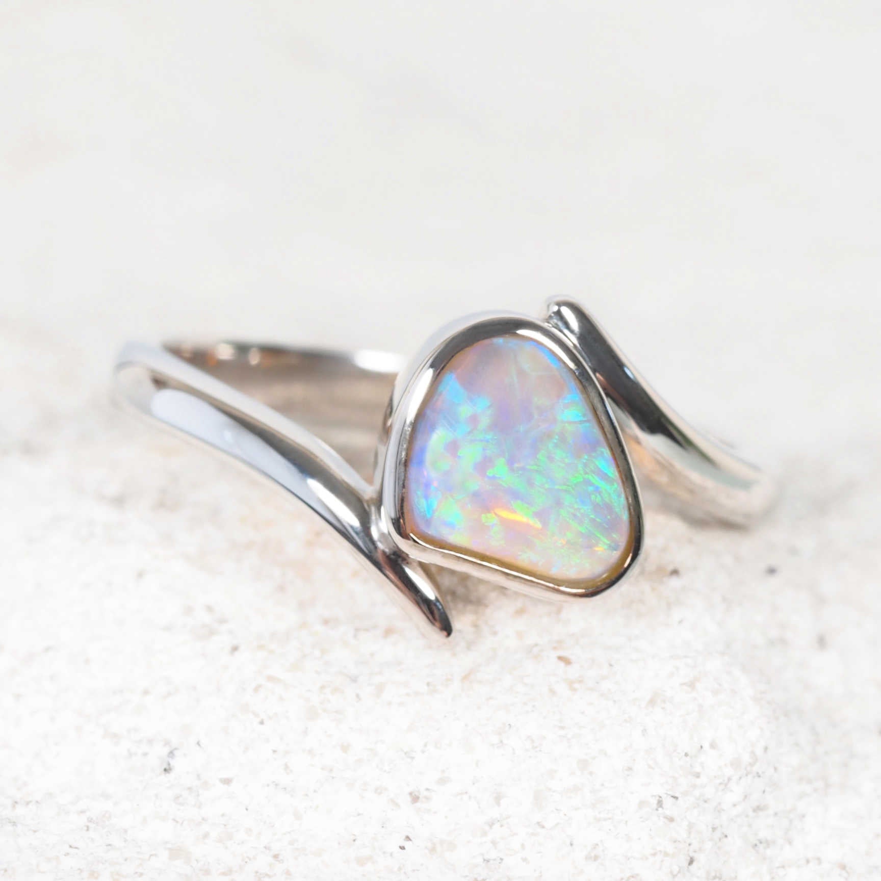 Green and blue South Australian opal ring in a bezel setting