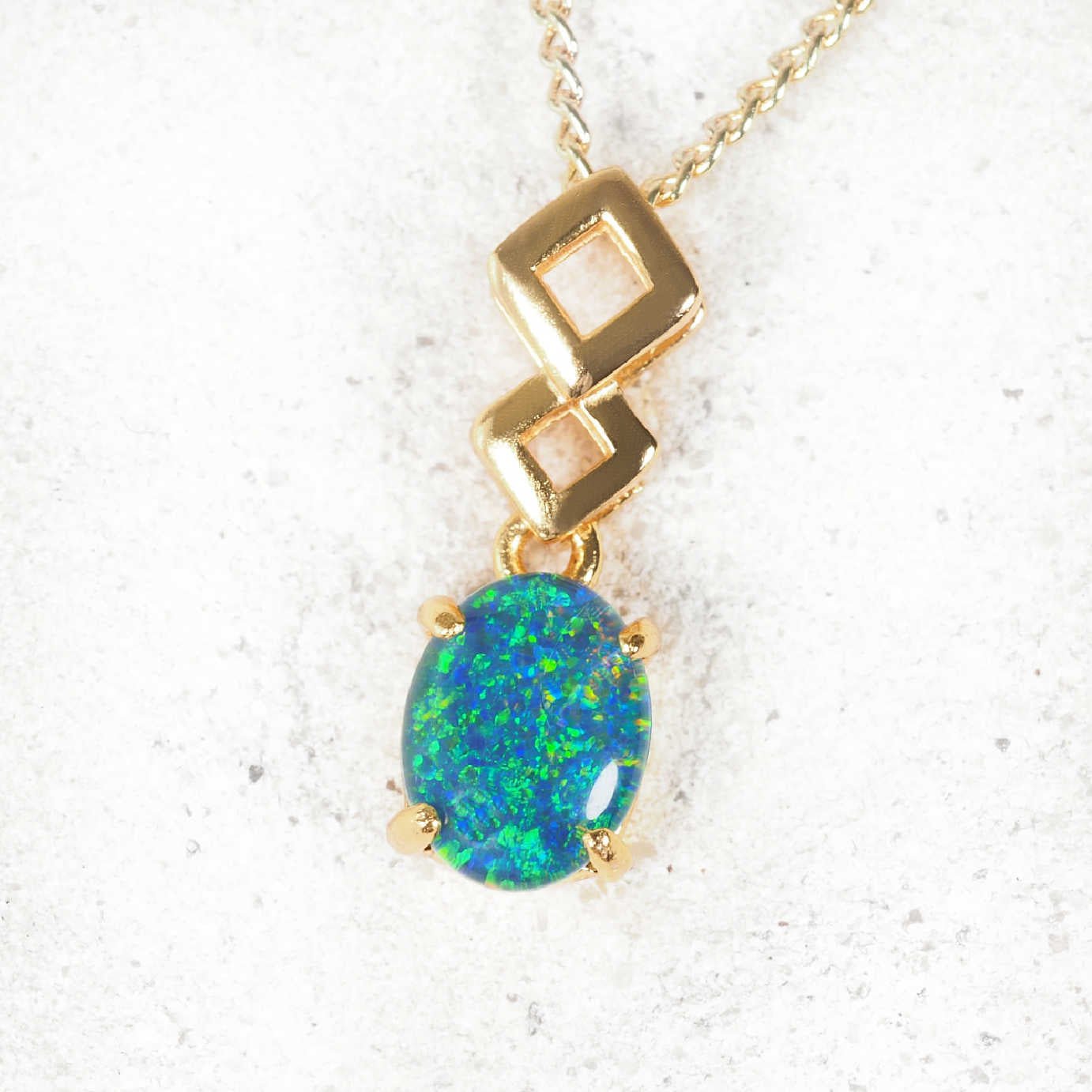 'Aria' opal pendant in gold-plated silver with contemporary drop design and claw-set oval Australian triplet opal
