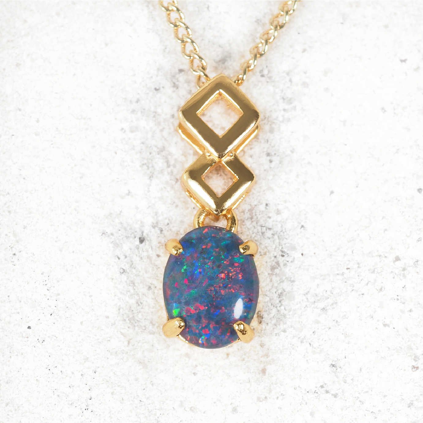 'Aria' opal pendant in polished gold-plated silver with contemporary drop design and claw-set oval Australian triplet opal