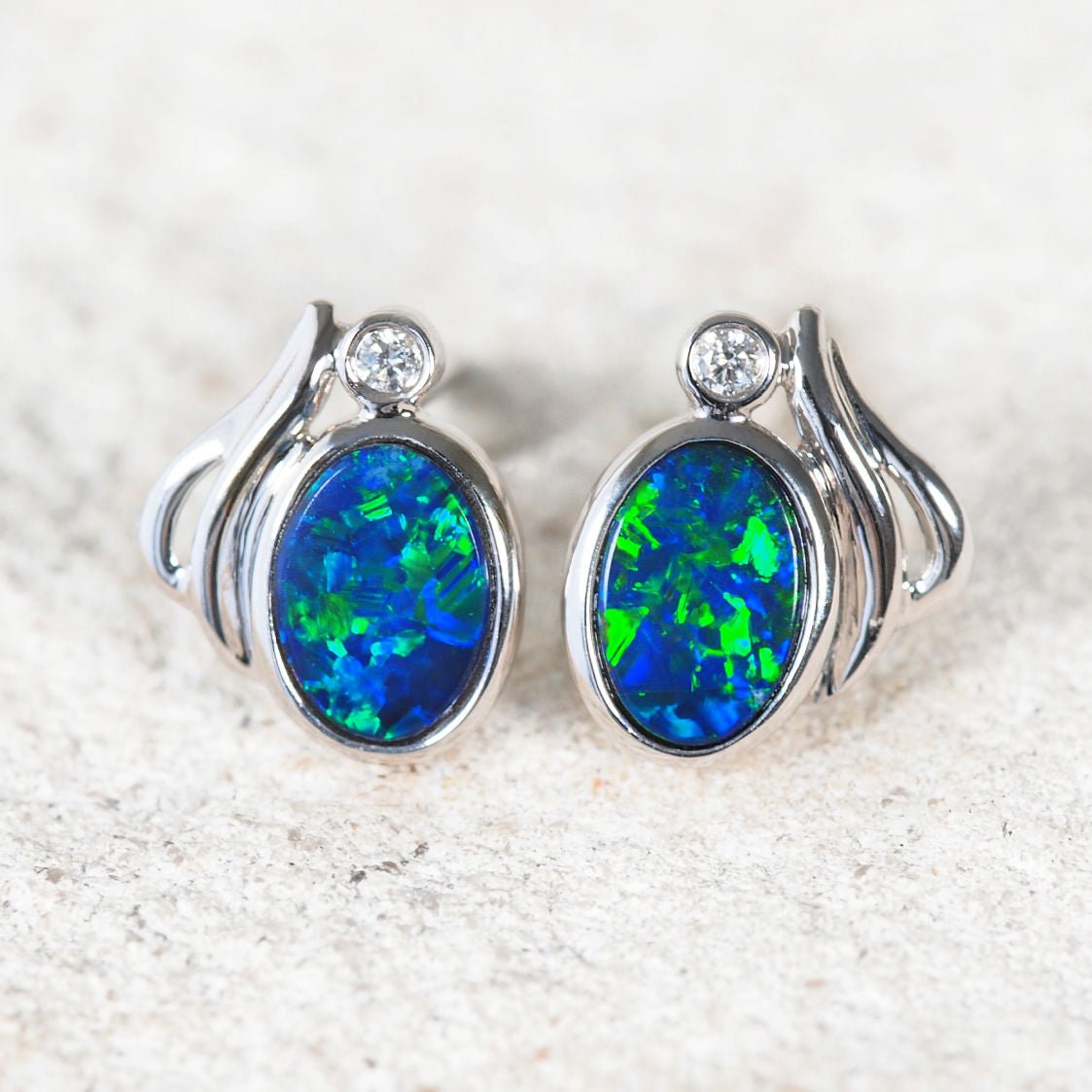 Ariel 14ct white gold stud earrings with oval Australian blue-green opals and diamonds