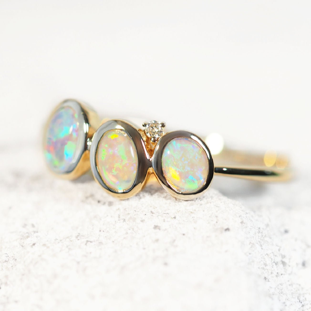Triple Australian crystal opal gold ring showing vivid blue-green play-of-colour