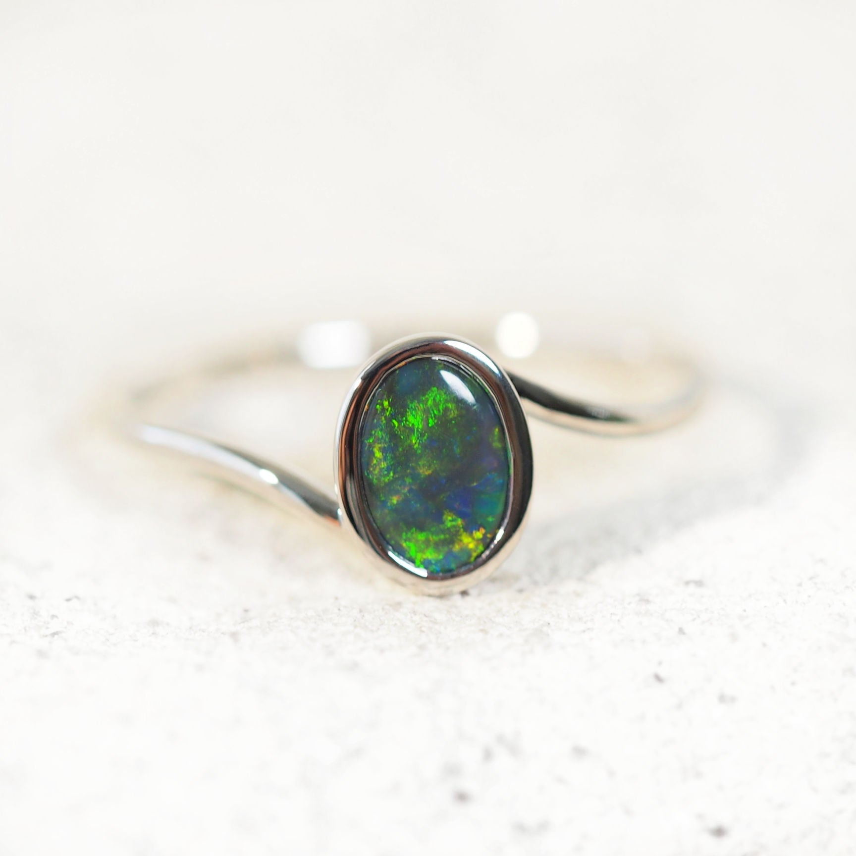 black opal ring with green tones