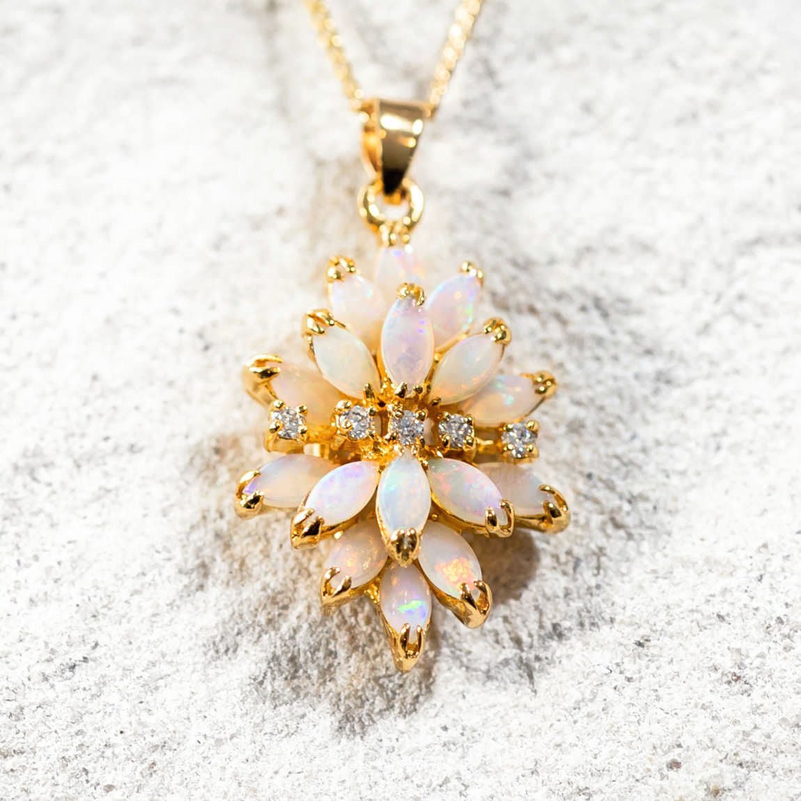 ornate opal pendant set with marquise shaped australian opals and five sparkling cubic zirconias